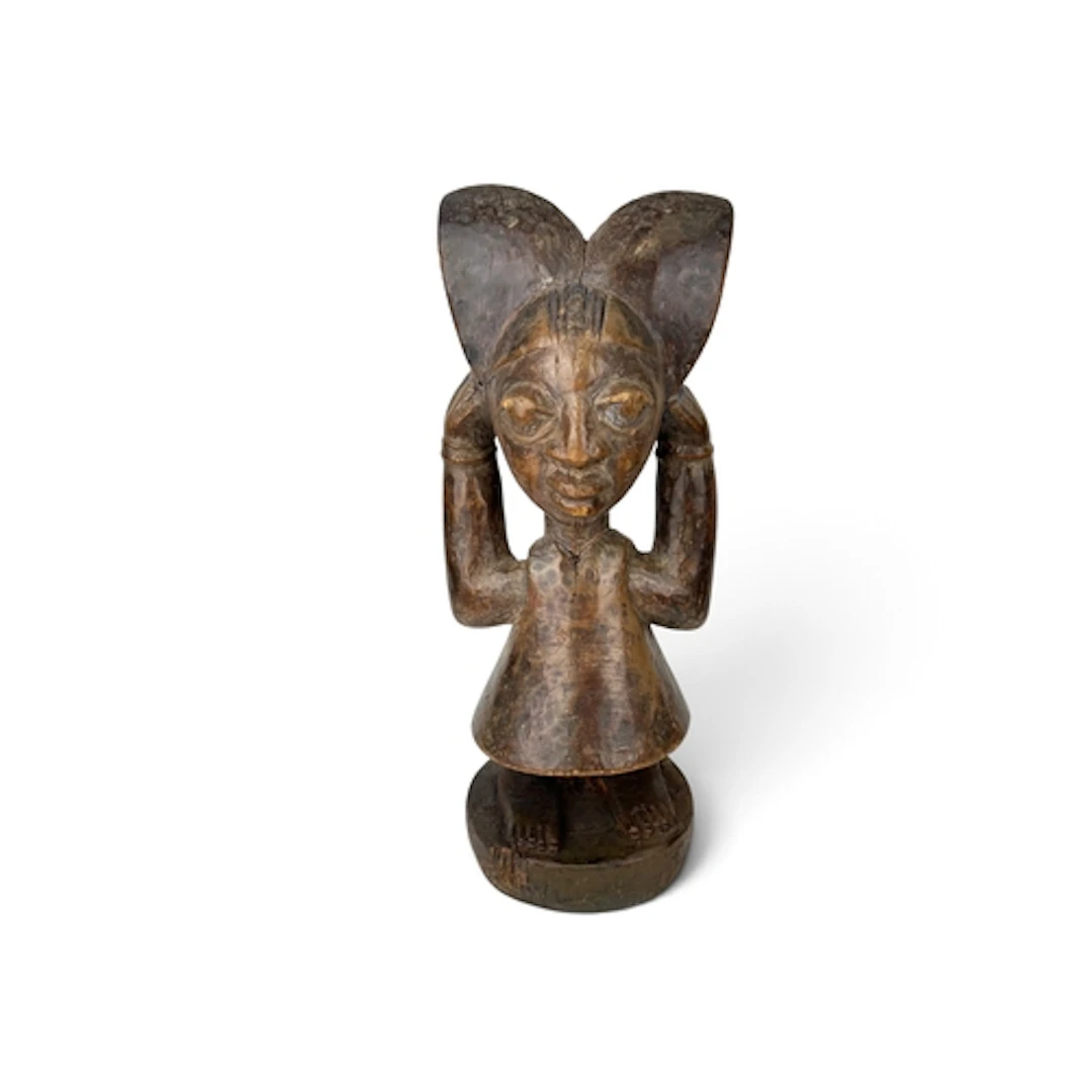 AN AFRICAN TRIBAL CARVED WOODEN SHRINE FIGURE, YORUBA In the...