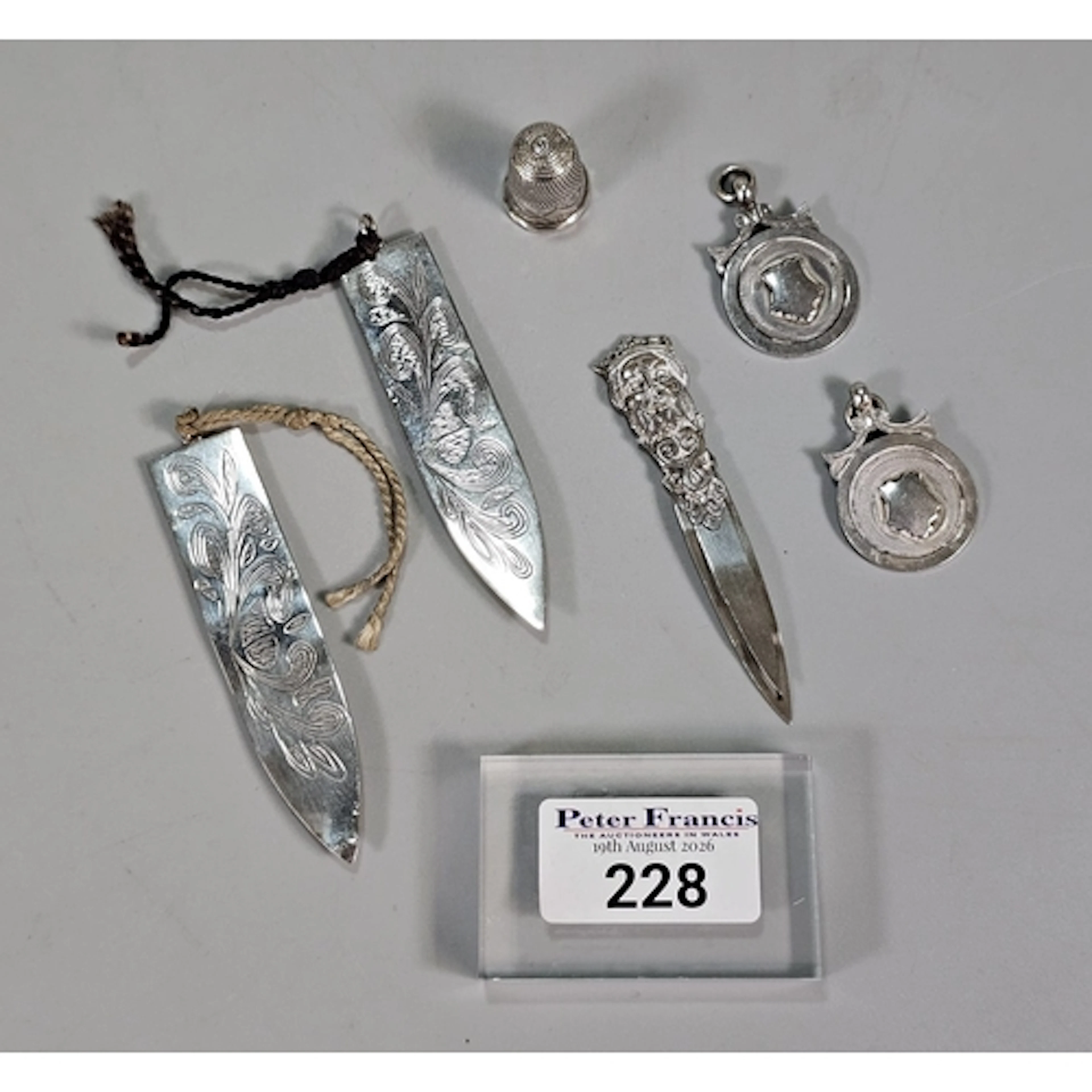 Bag of silver items to include: thimble, two fobs and three ...