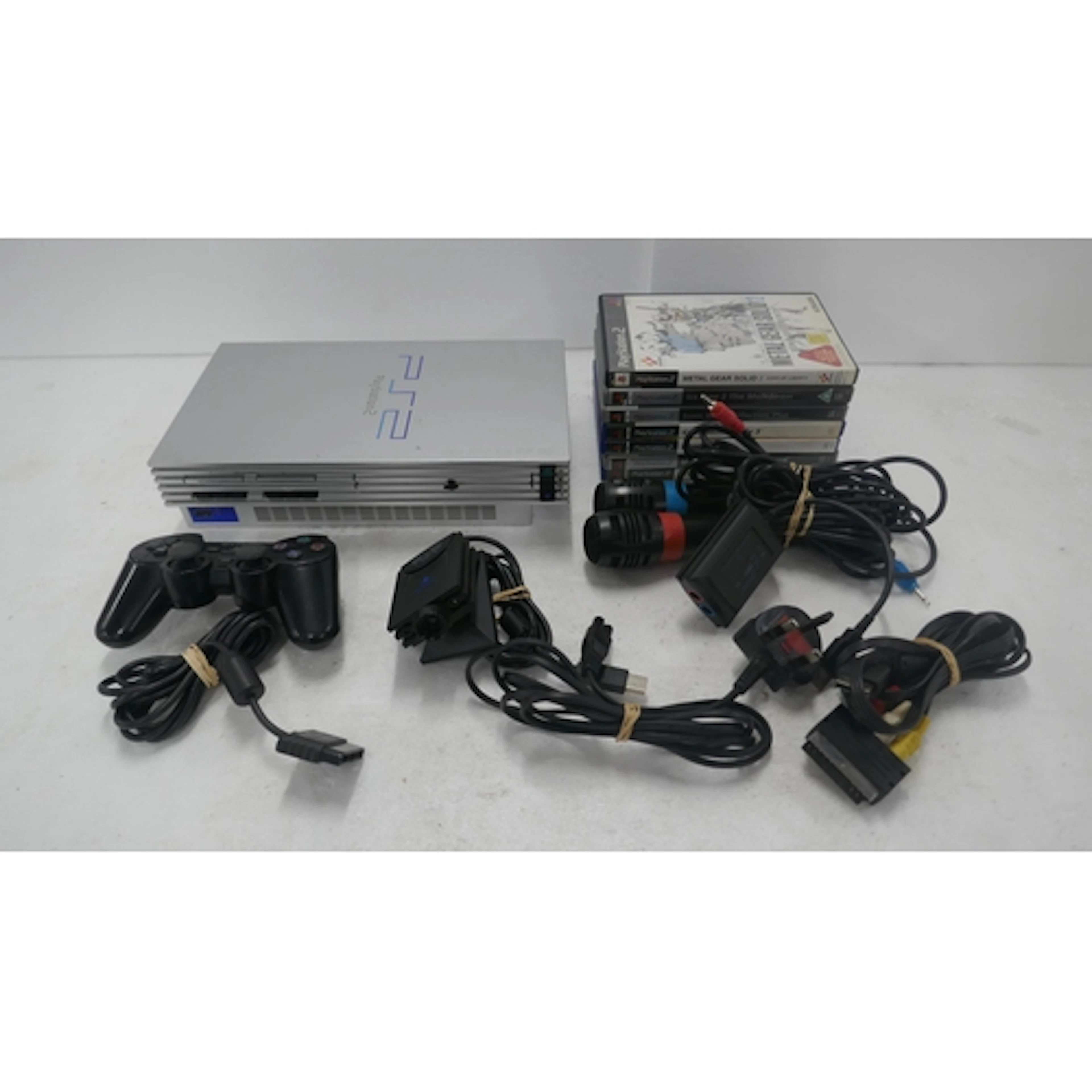 A satin silver PlayStation 2 games console with a Sony Duals...