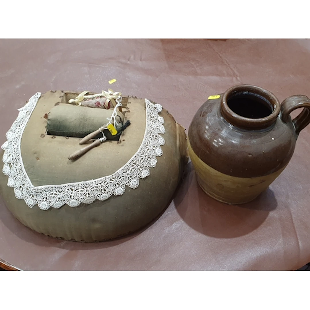 A Lacemaker's Cushion, a lace Collar and a stoneware Jar wit...