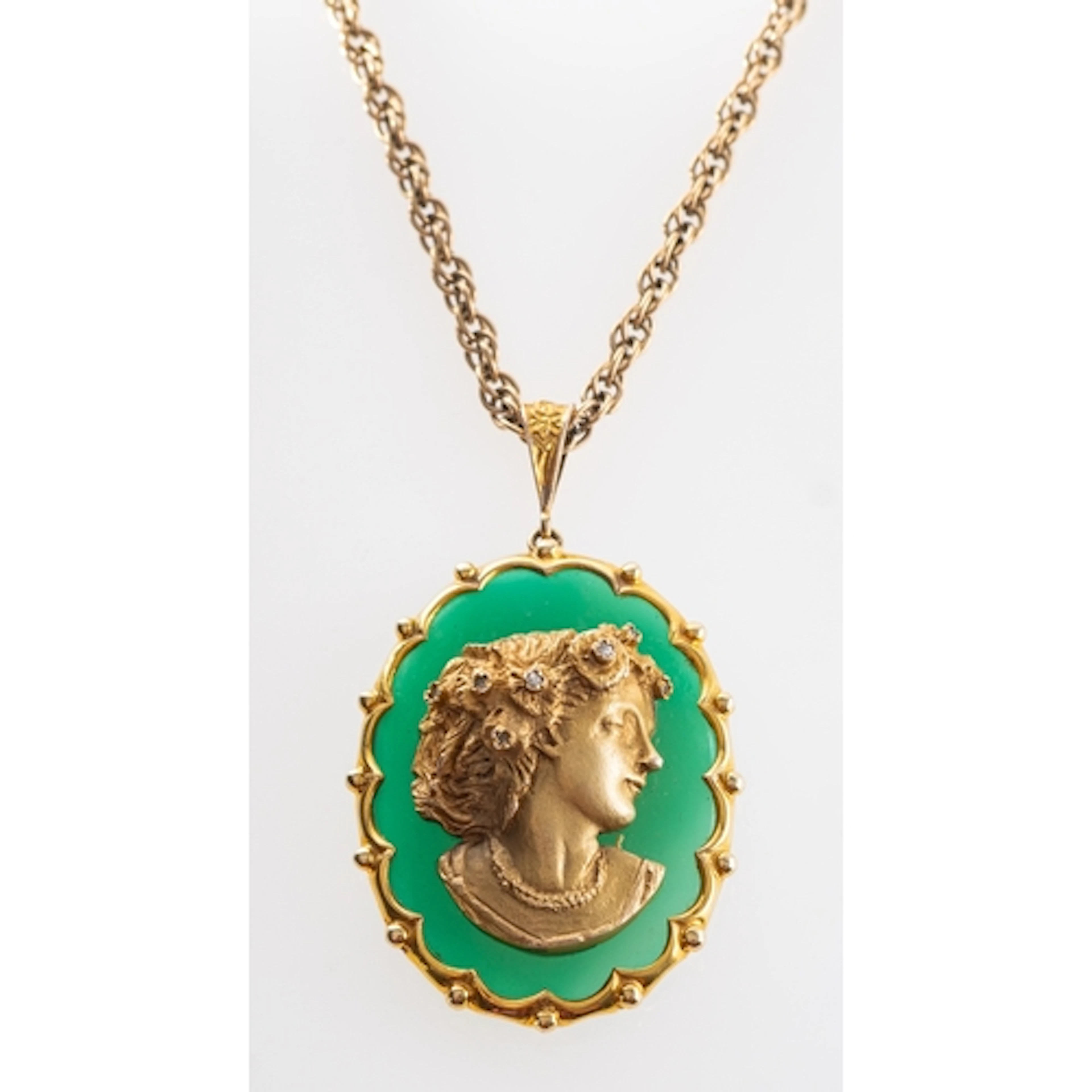 A 1970s 9ct gold relief cameo pendant set with six single cu...