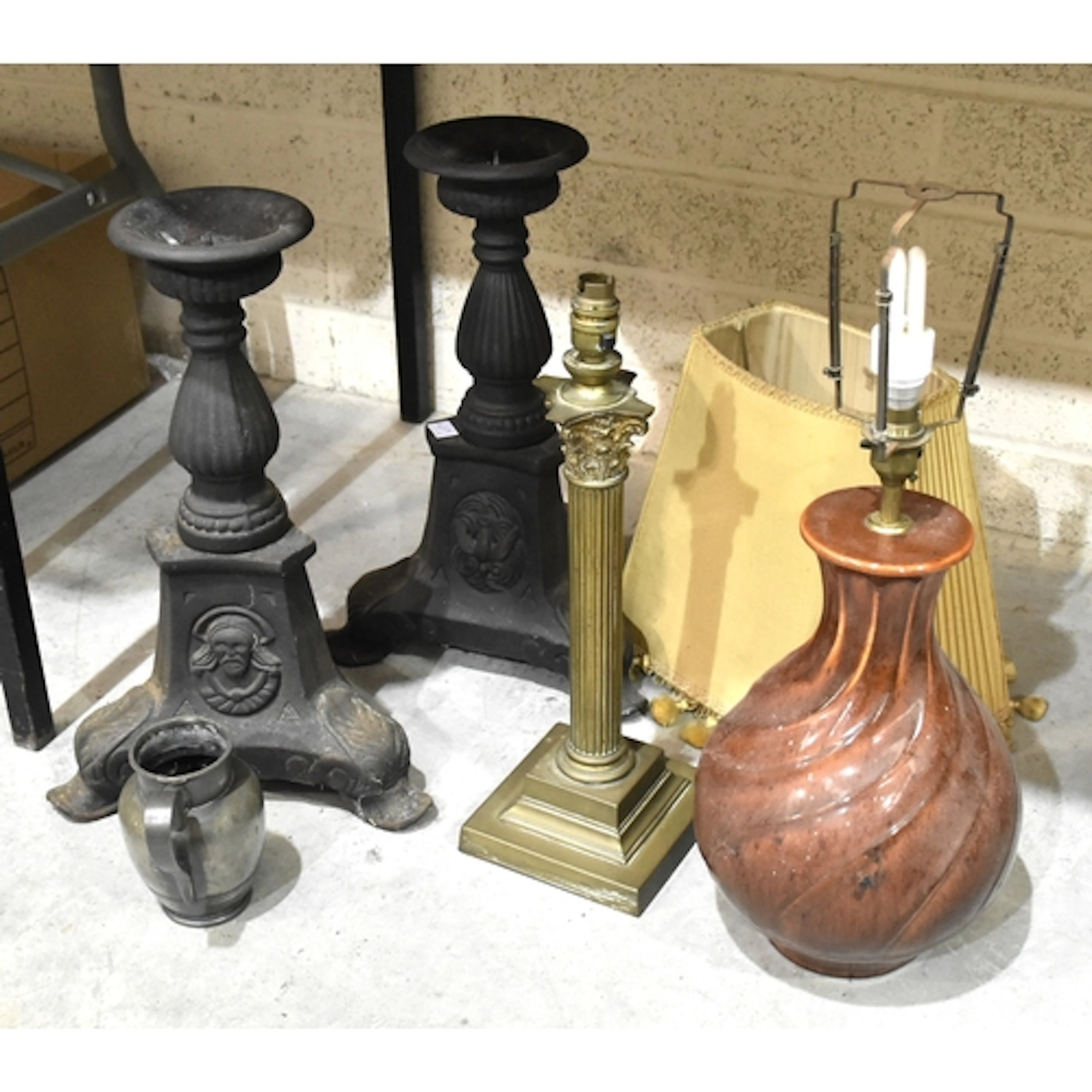 A pair of cast iron pricket candlesticks on triform supports...