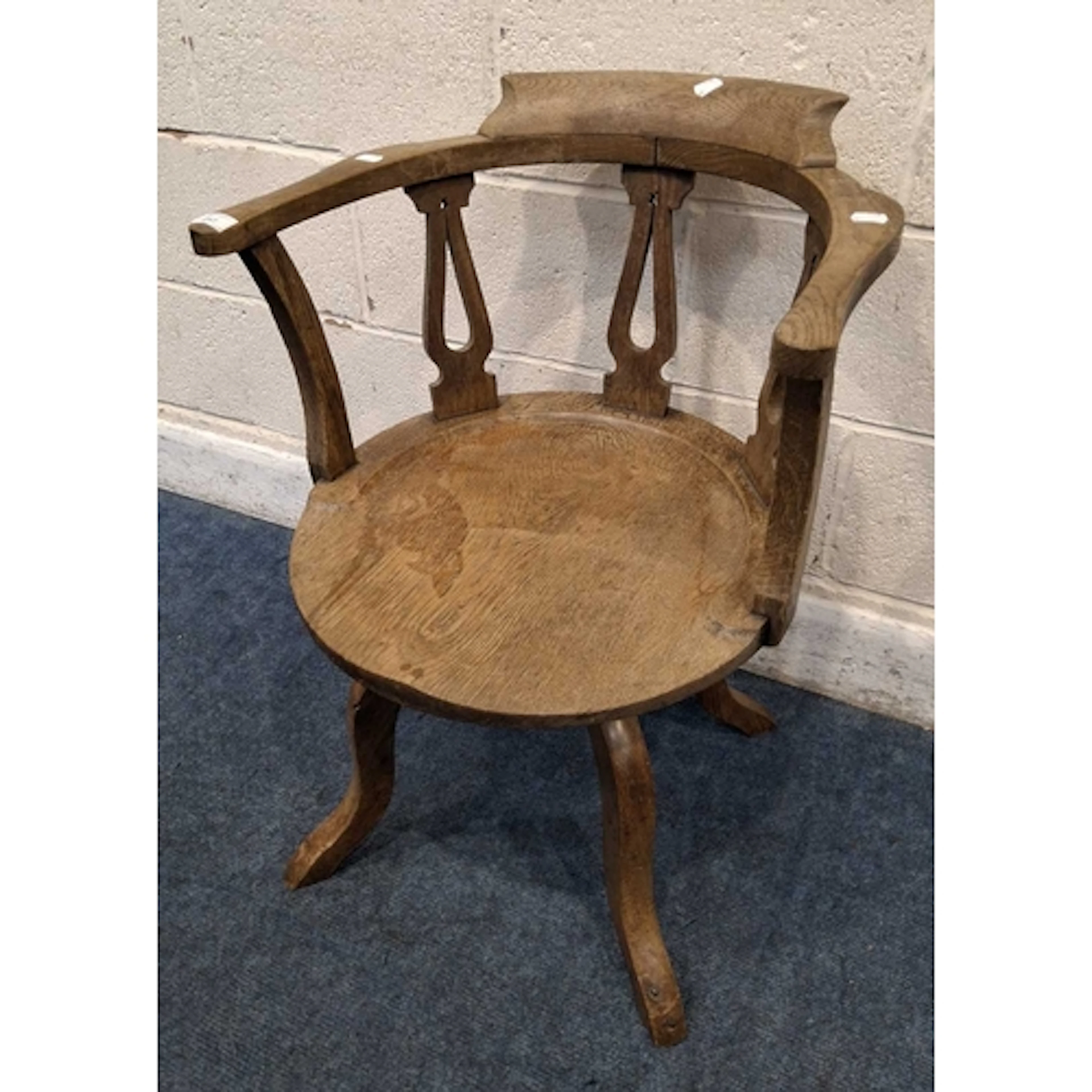 AN EARLY 20TH CENTURY OAK BOW TOP CAPTAINS SWIVEL CHAIR, wit...