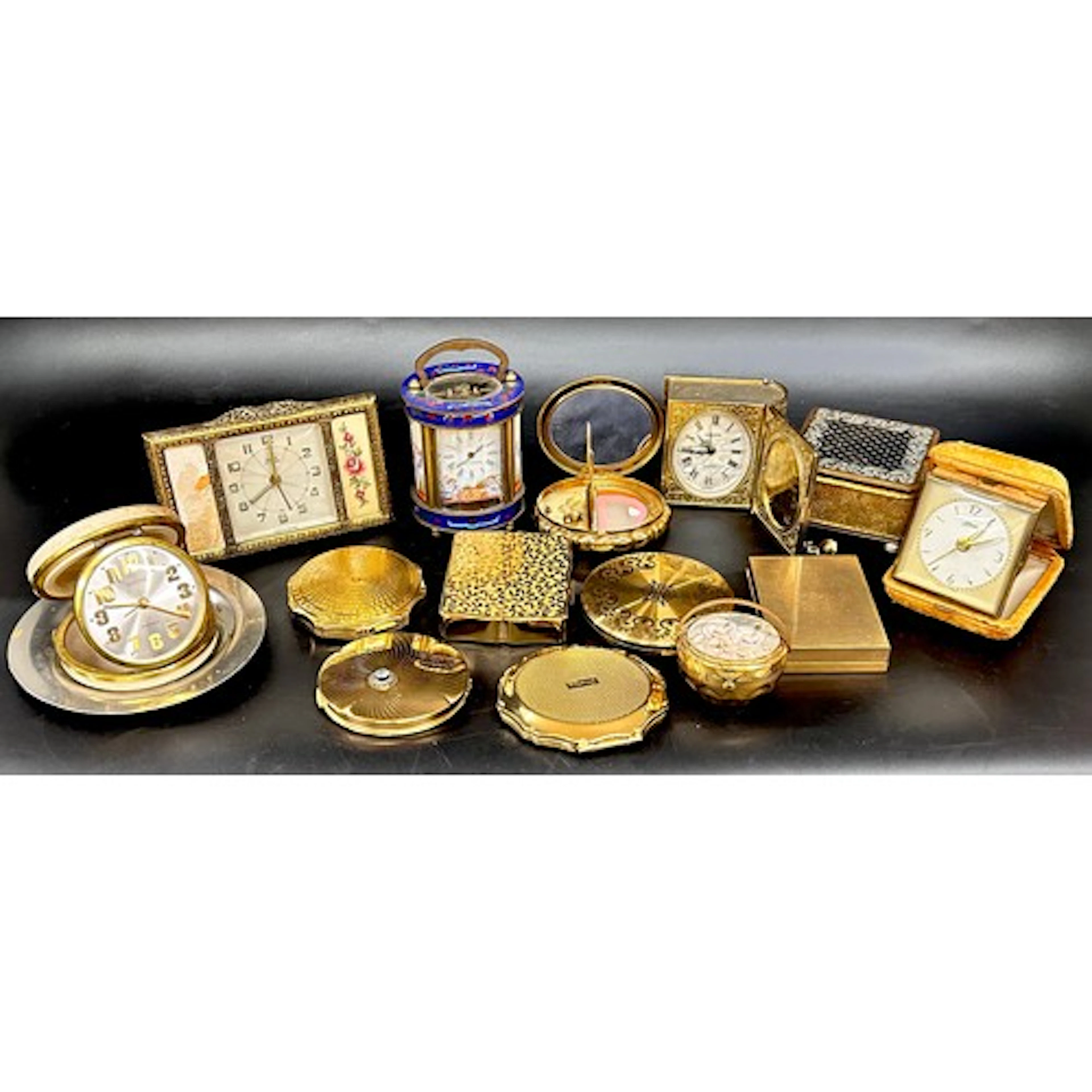 A collection of compacts including Stratton, Kigu, and Vanit...