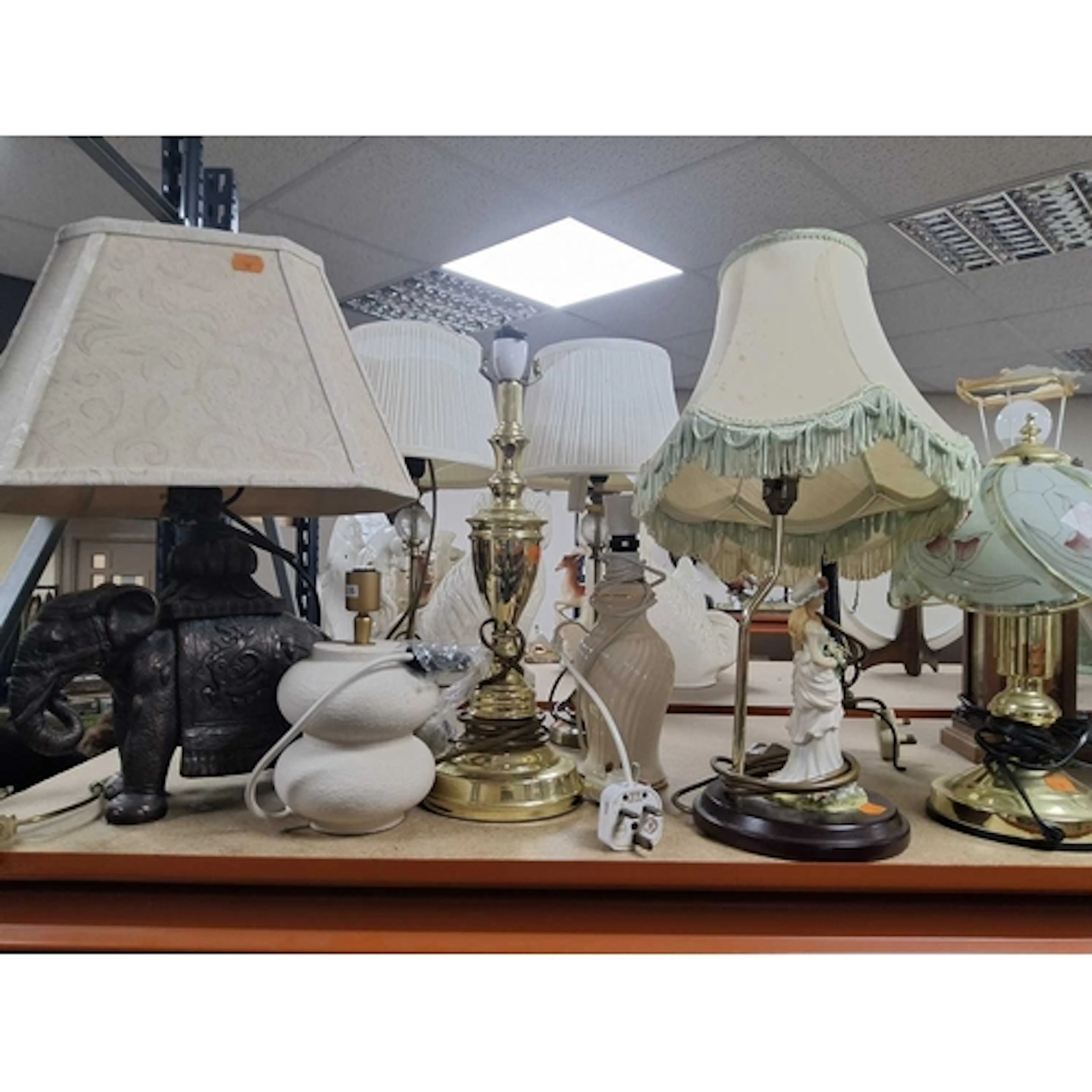 A GROUP OF LAMPS AND ORNAMENTS to include a composite table ...