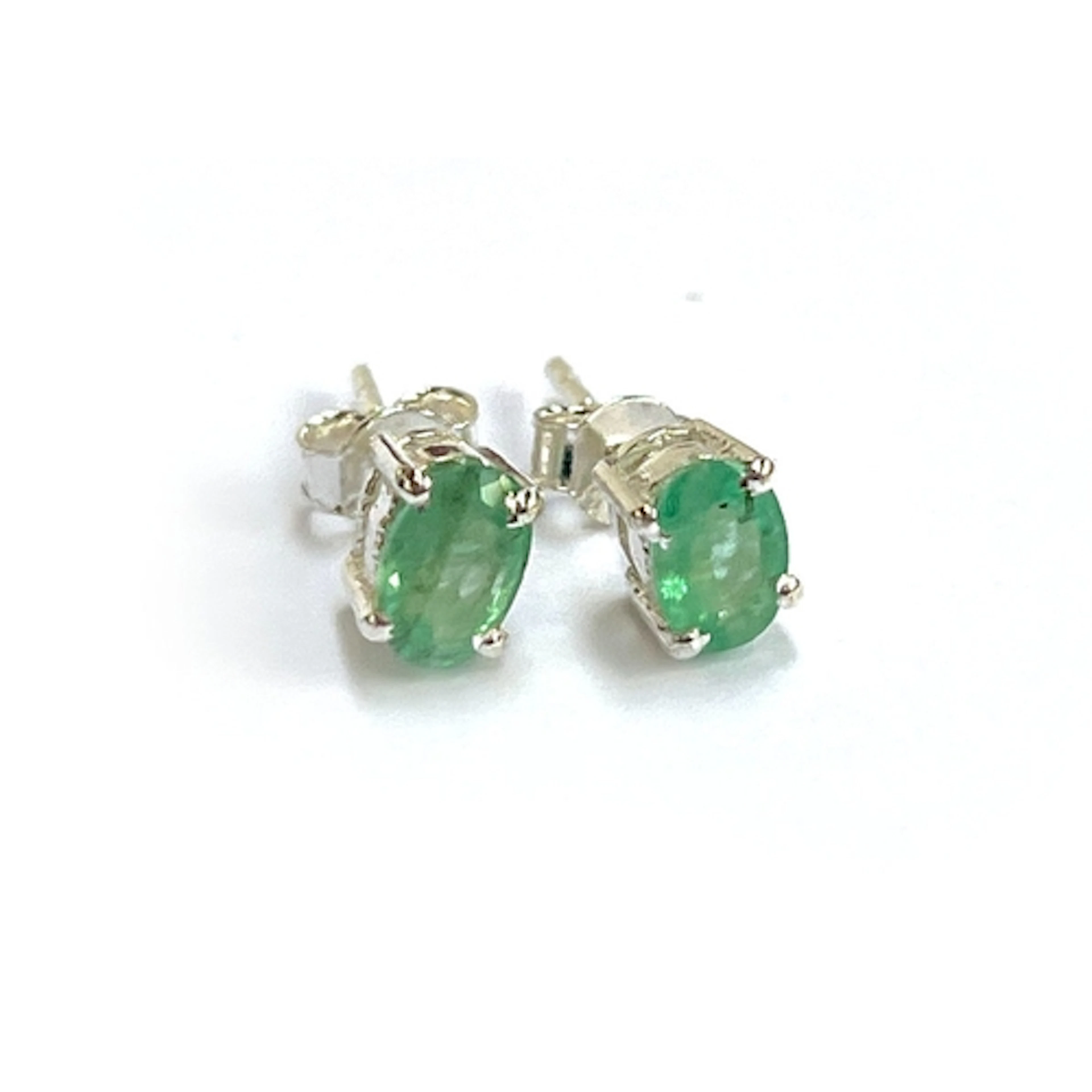 Pair of oval emerald studs, set in silver. Emeralds approx. ...