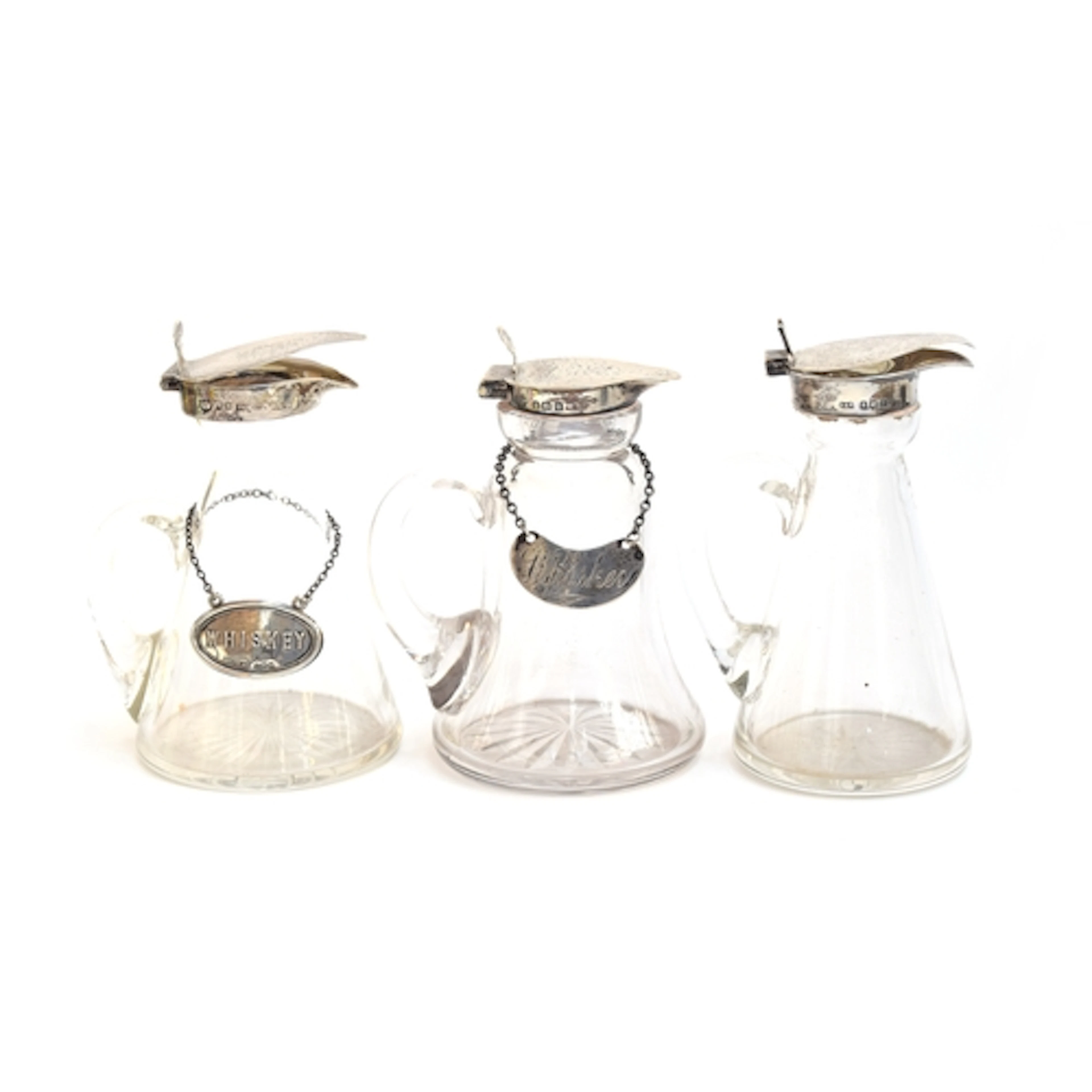 A lot of three silver topped glass whiskey noggins, various ...