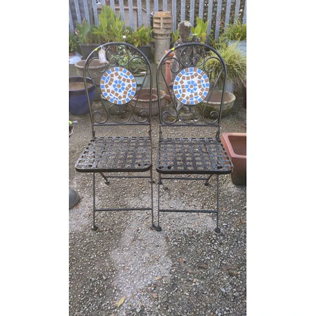 A pair of folding black-painted metal garden chairs, each wi...