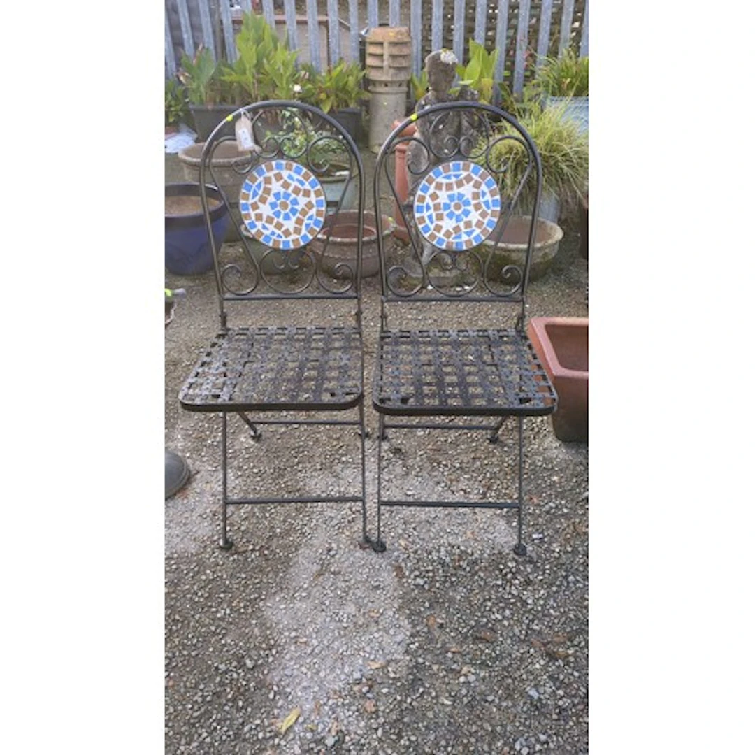 A pair of folding black-painted metal garden chairs, each wi...