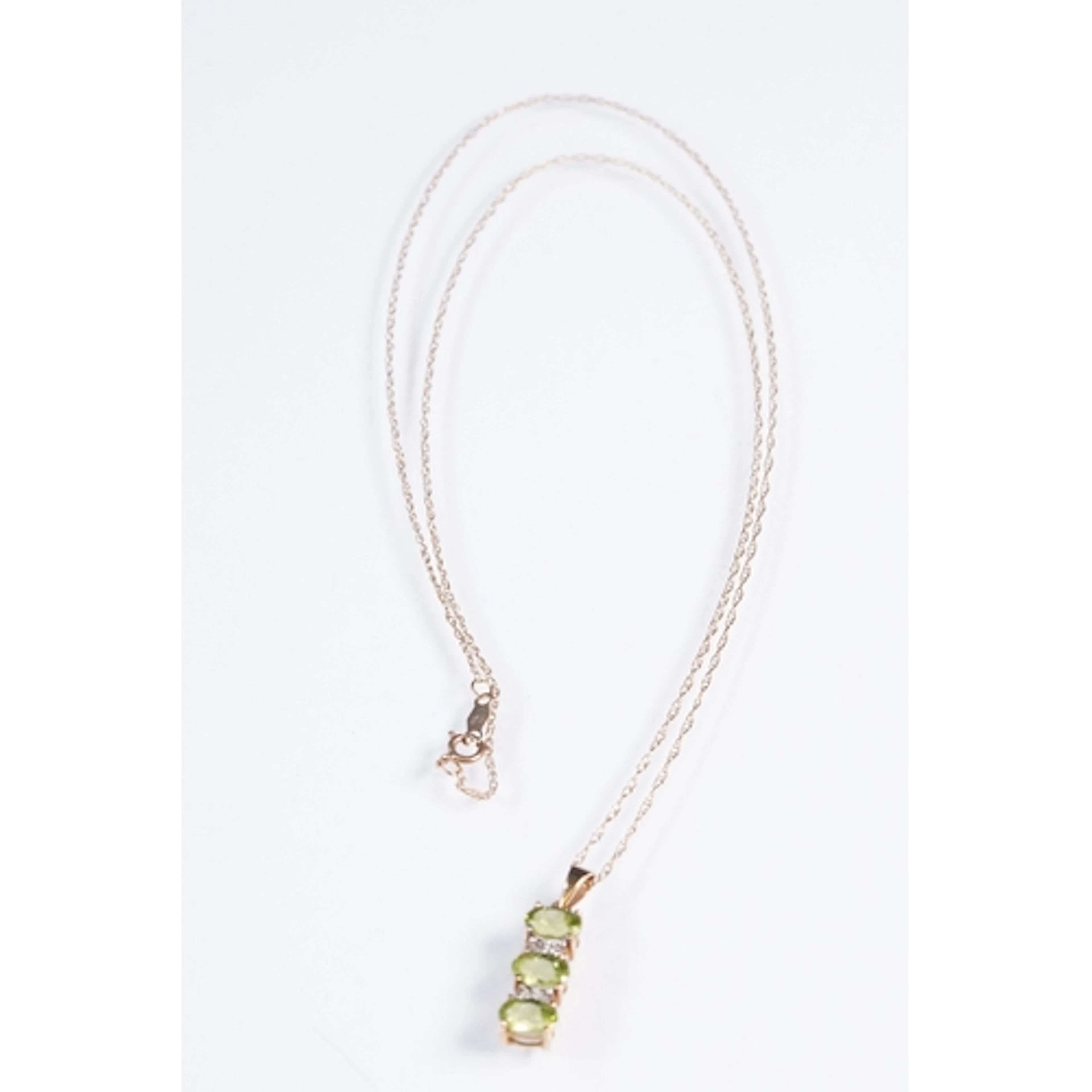 9ct gold and peridot pendant necklace. The necklace having a...
