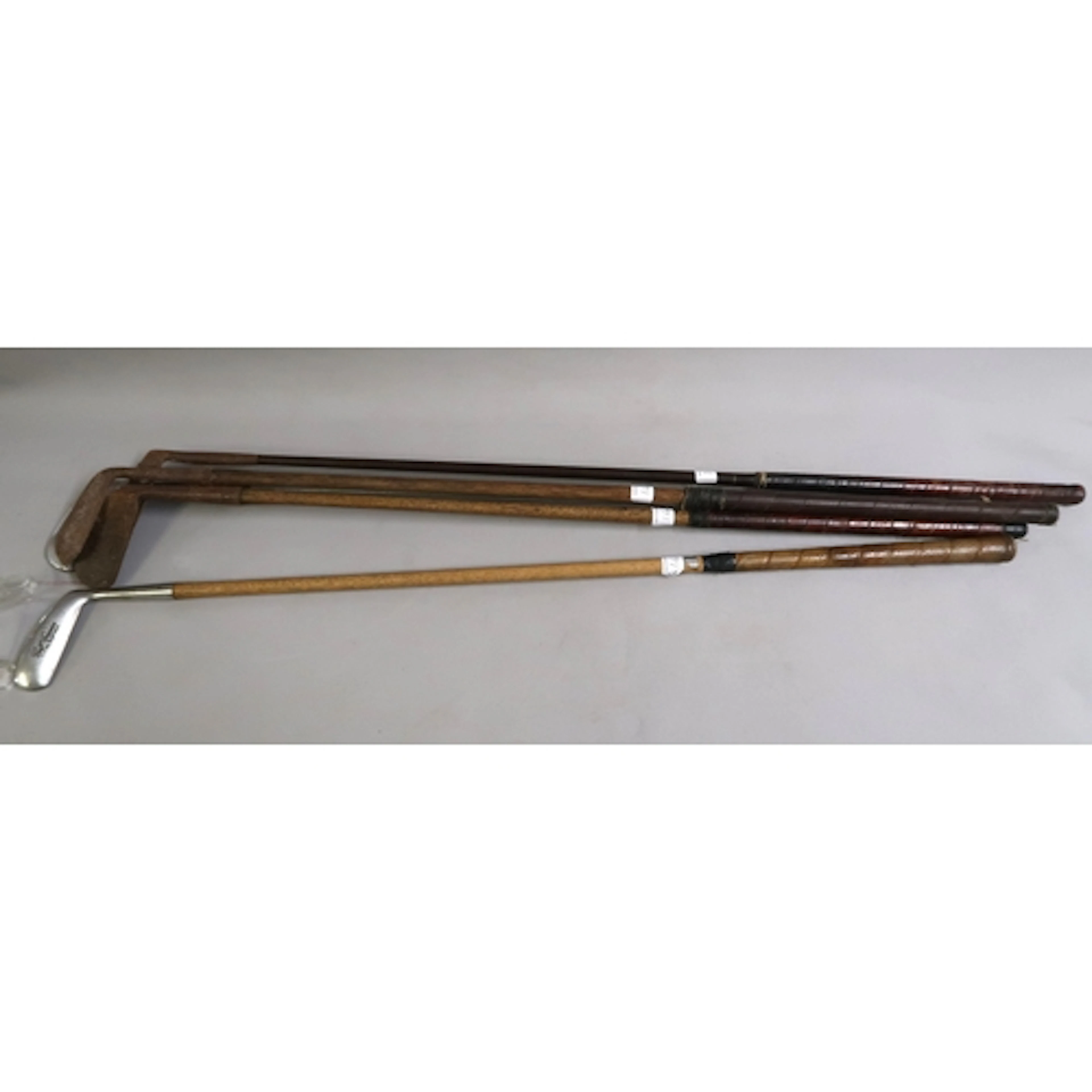 Three antique hickory shafted antique golf clubs, a framed d...
