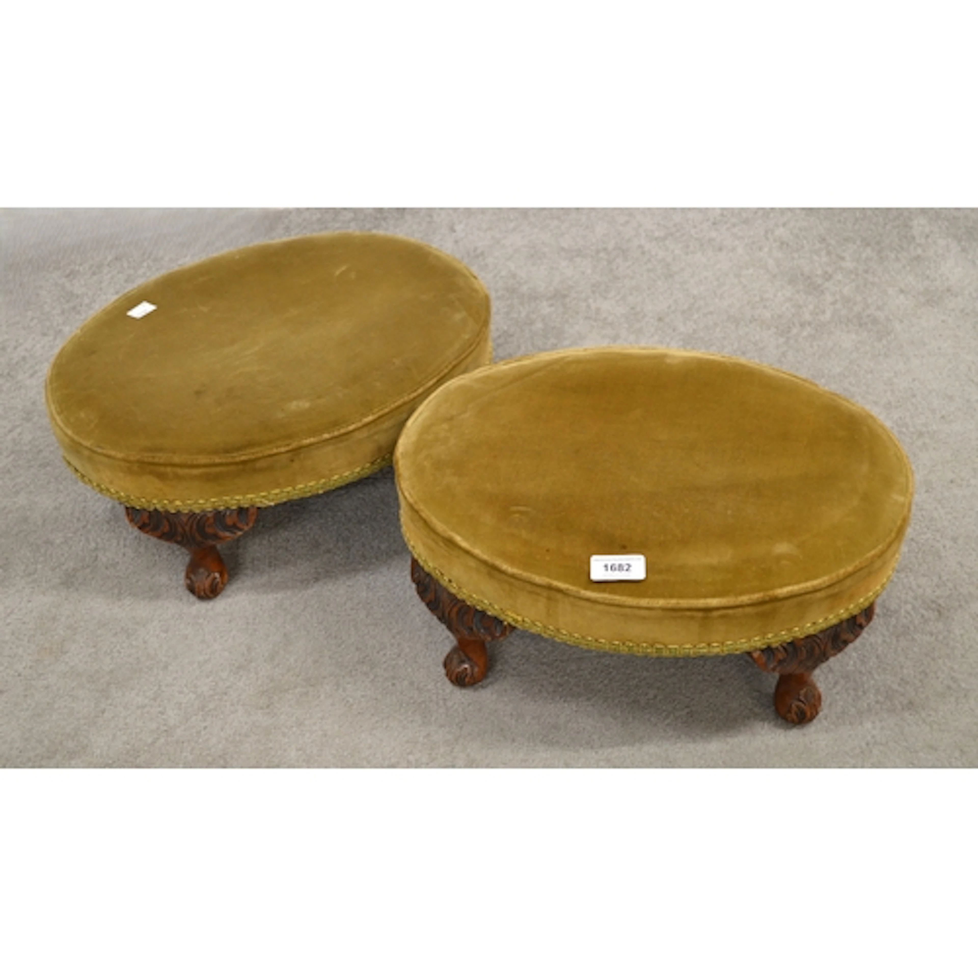 Pair of oval upholstered footstools, on walnut carved cabrio...