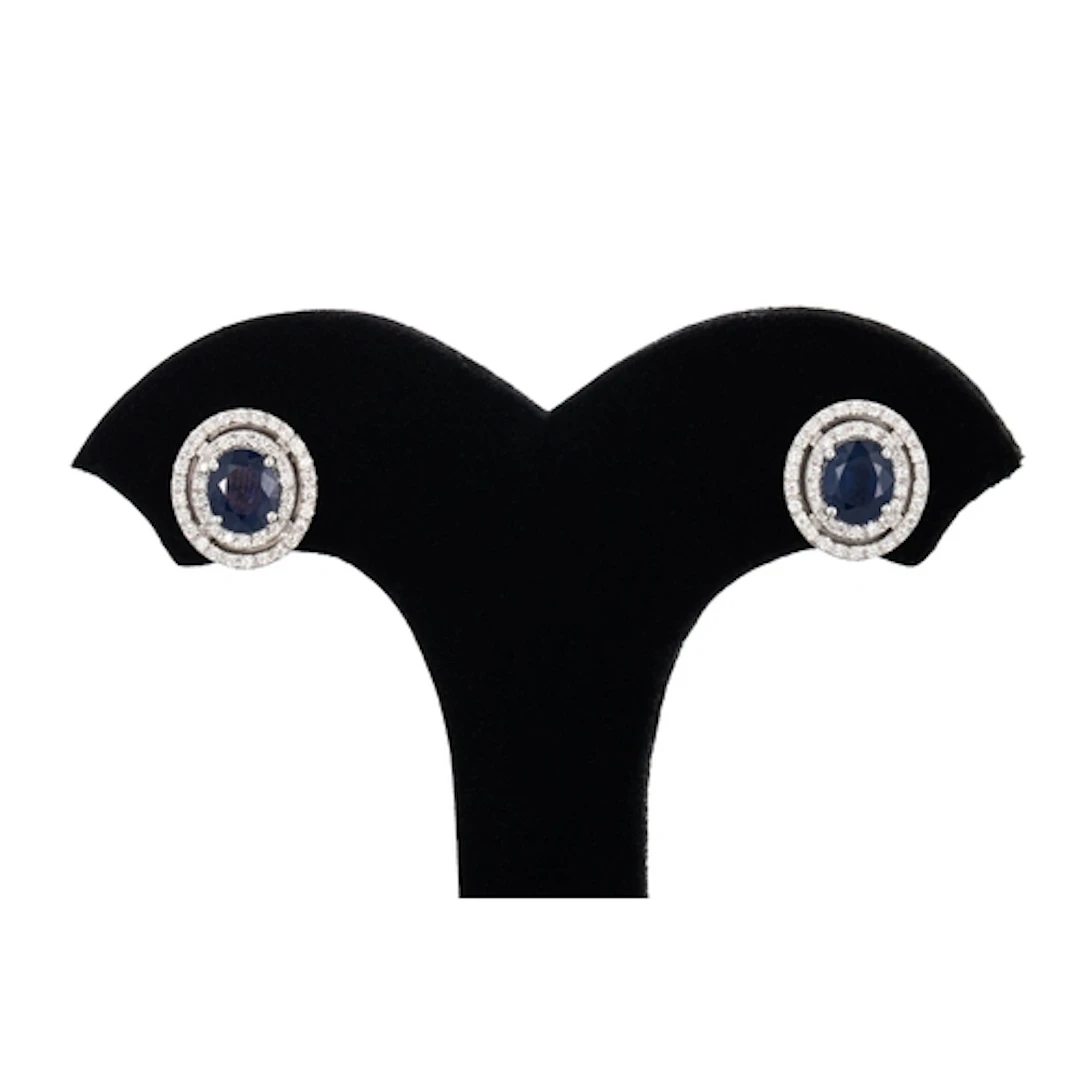 A PAIR OF SAPPHIRE AND DIAMOND CLUSTER EARRINGS, the oval sa...