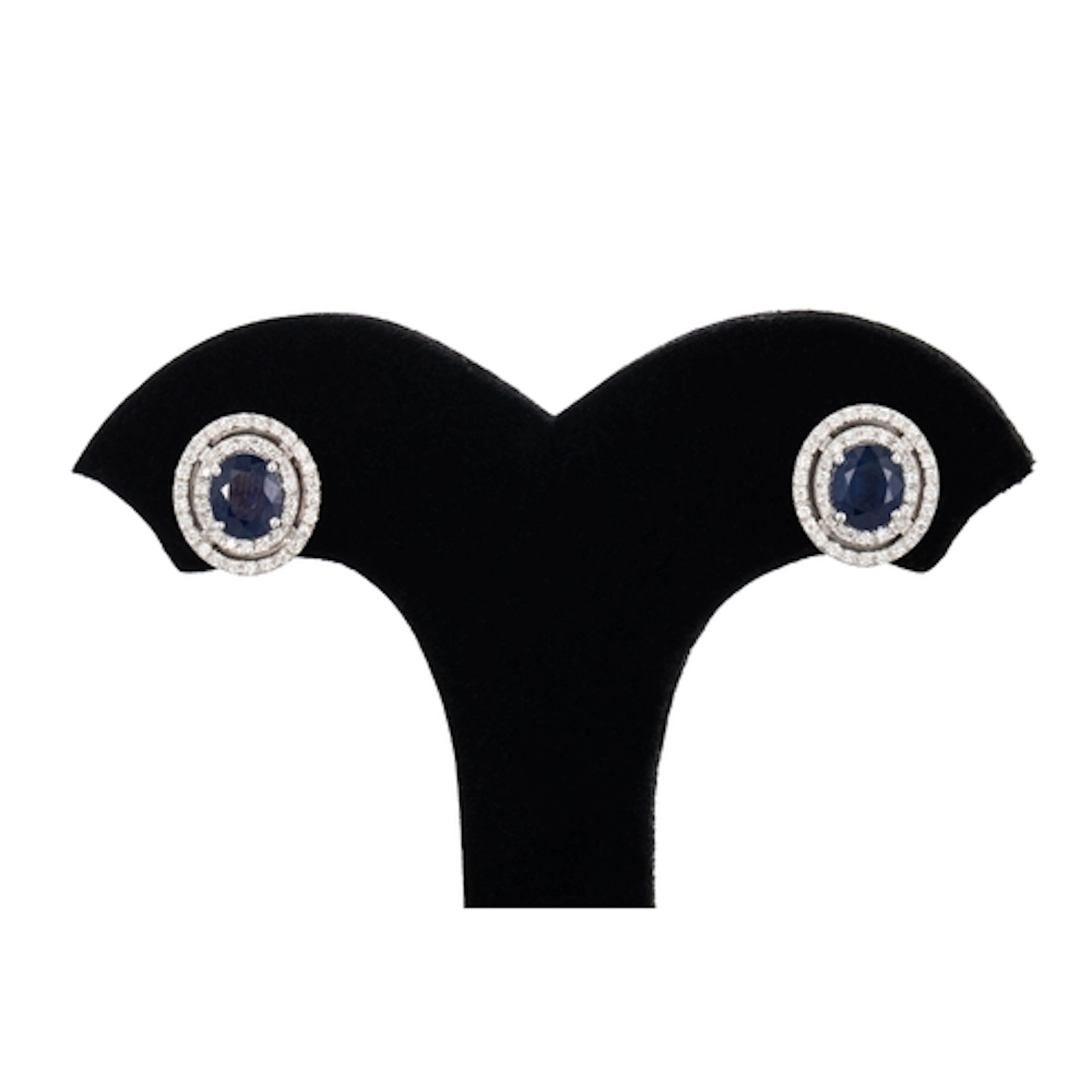 A PAIR OF SAPPHIRE AND DIAMOND CLUSTER EARRINGS, the oval sa...