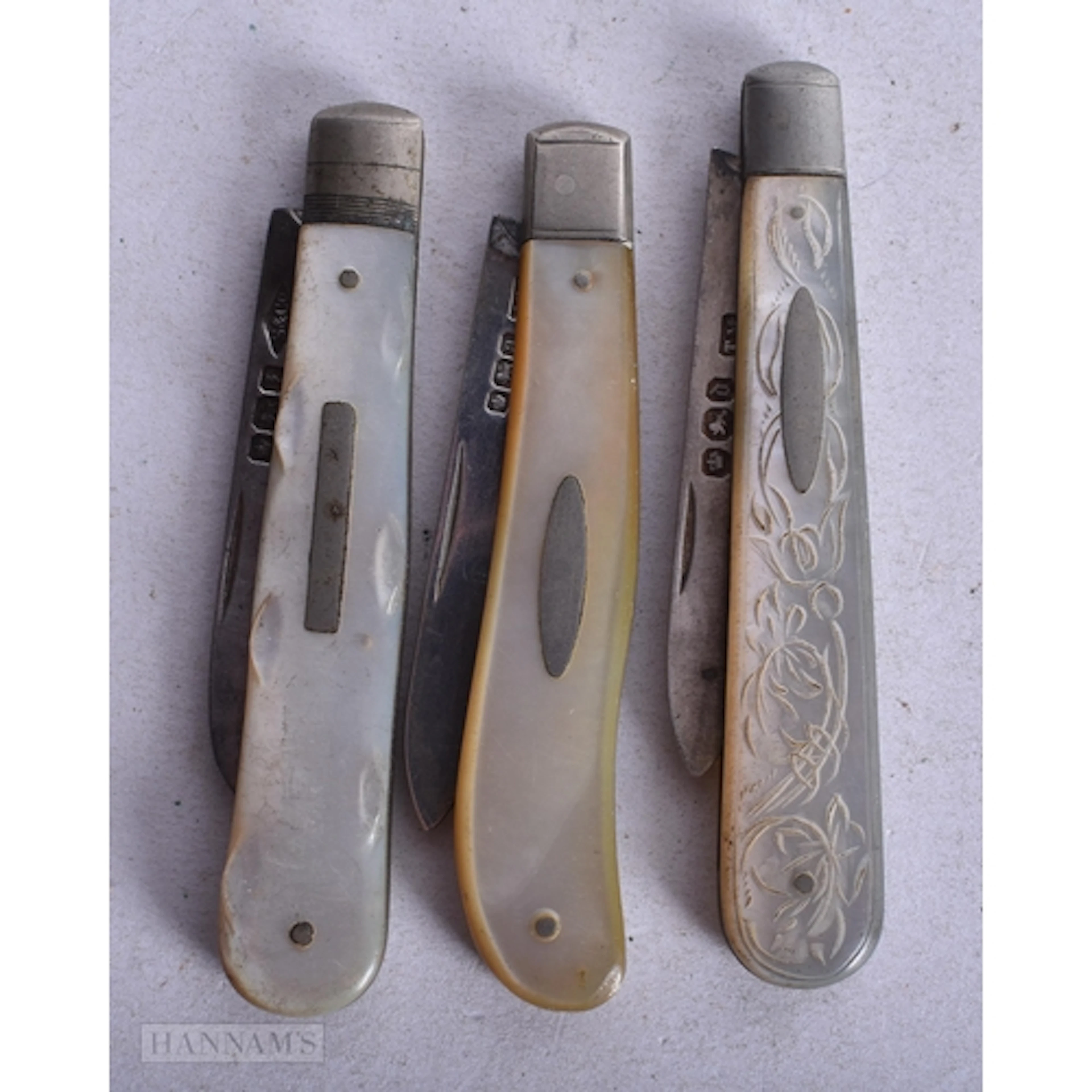 THREE ANTIQUE SILVER AND MOTHER OF PEARL FRUIT KNIVES. (3)