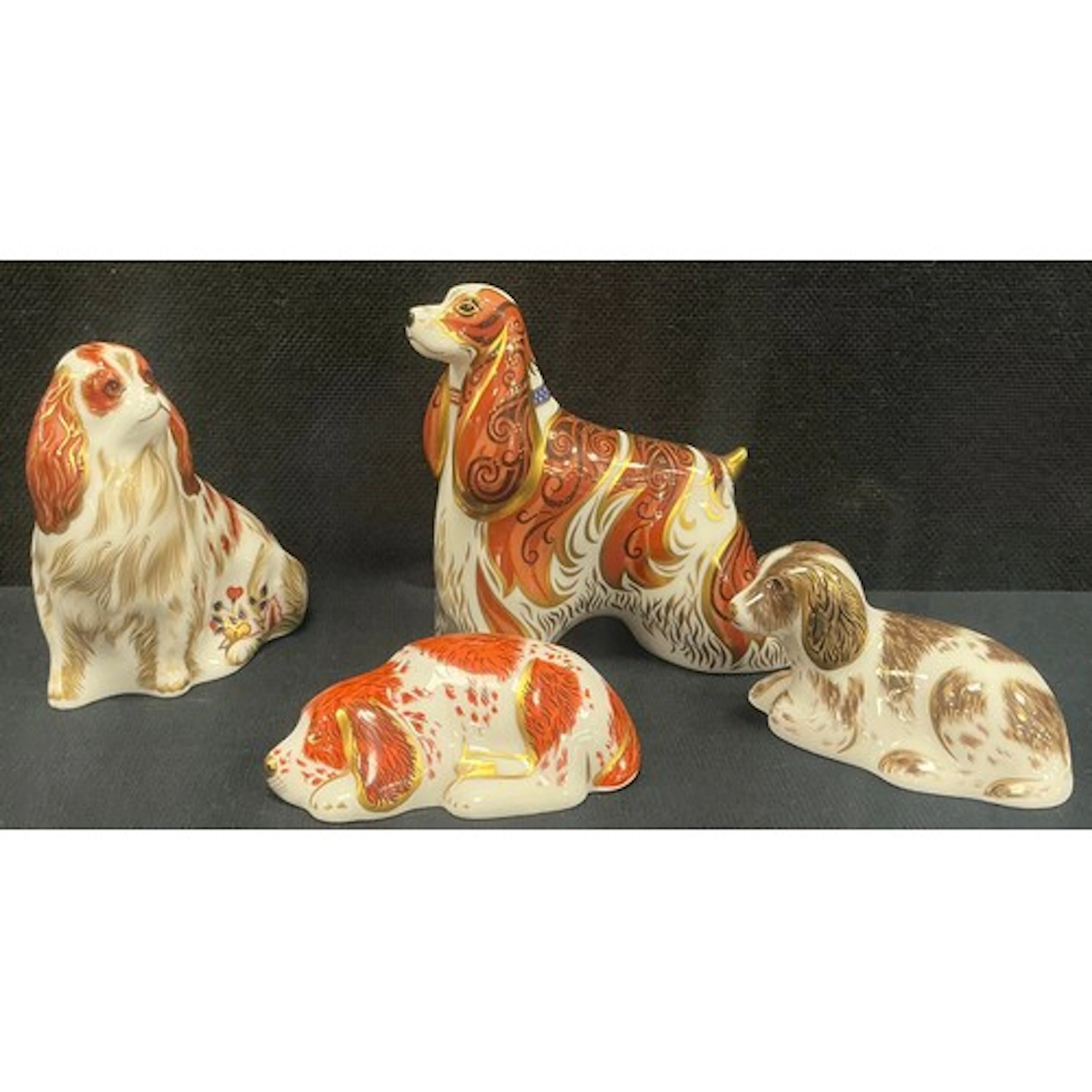 Royal Crown Derby - four paperweights, American Spaniel, Cav...