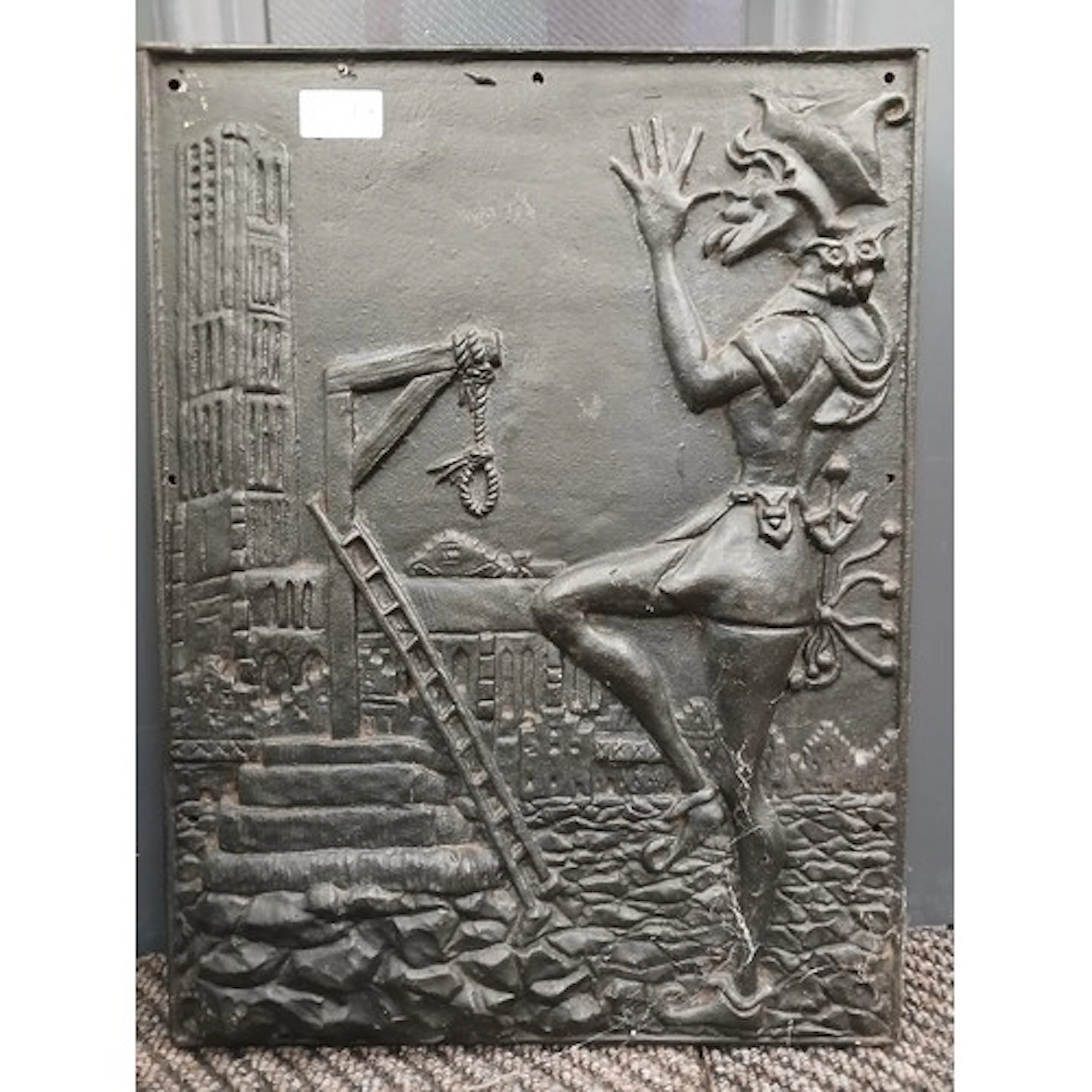 Wrought iron plaque depicting a Jester in front of a gallows...
