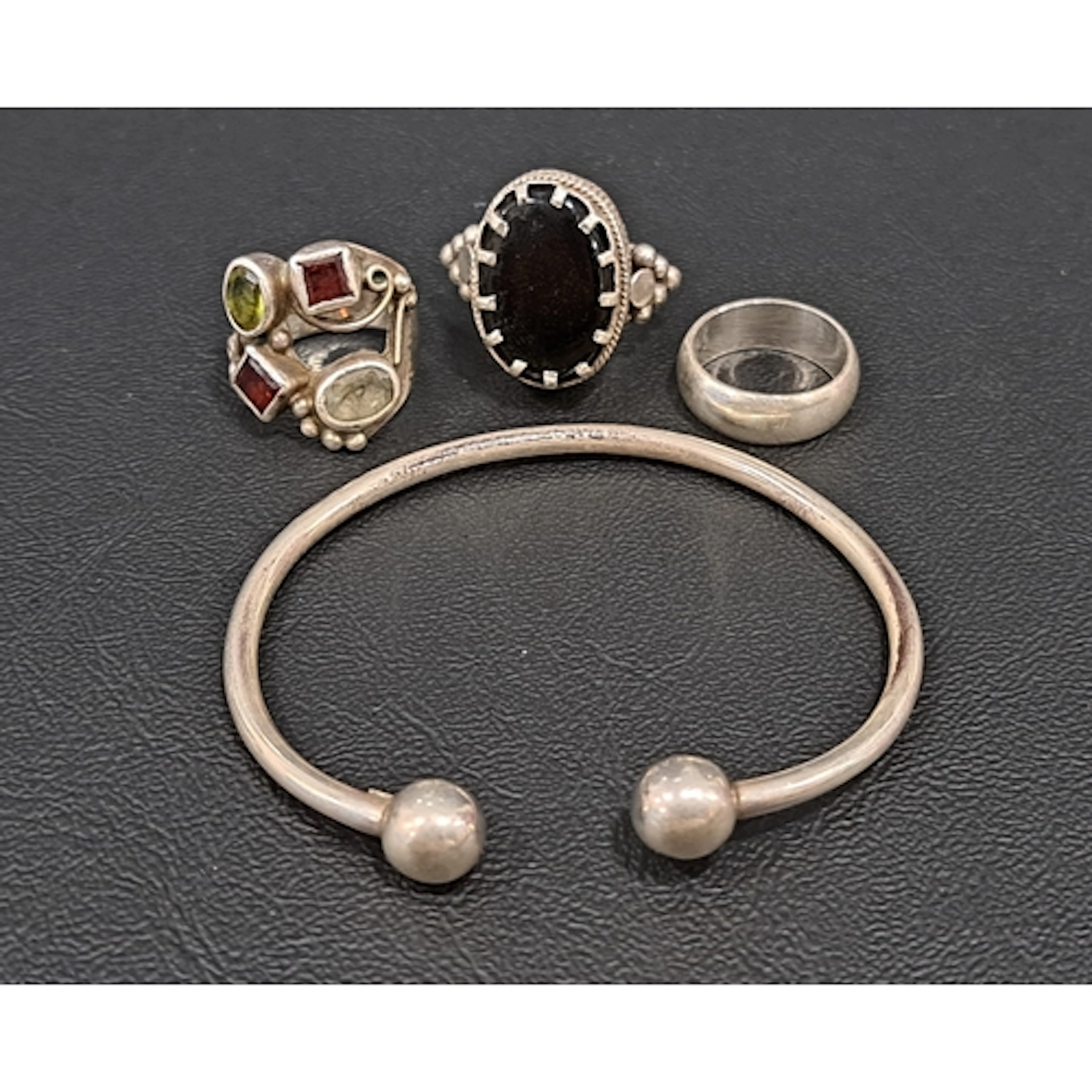 FOUR PIECES OF SILVER JEWELLERY comprising a multi gem set r...