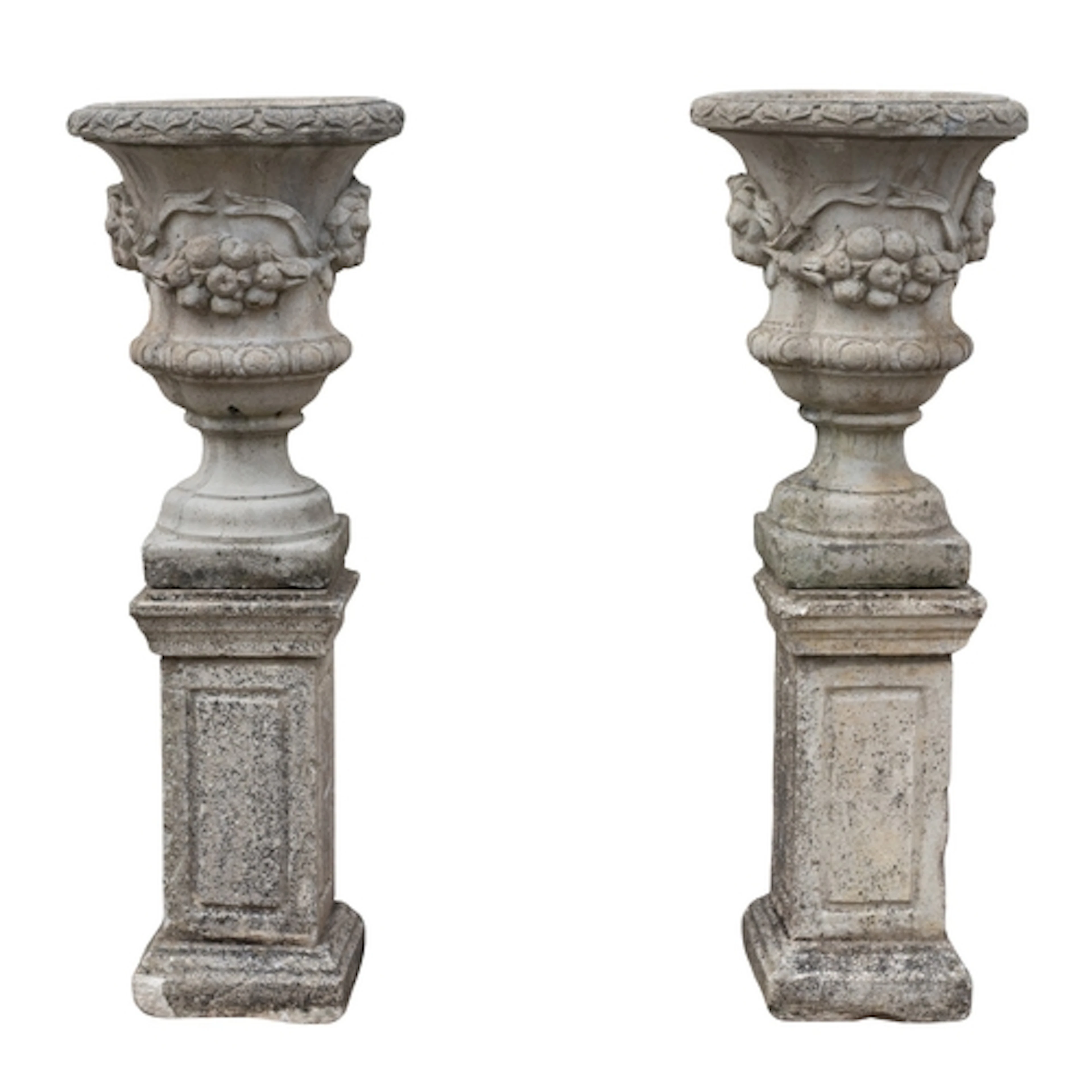 A pair of stone composition garden urns on plinths, 20th cen...
