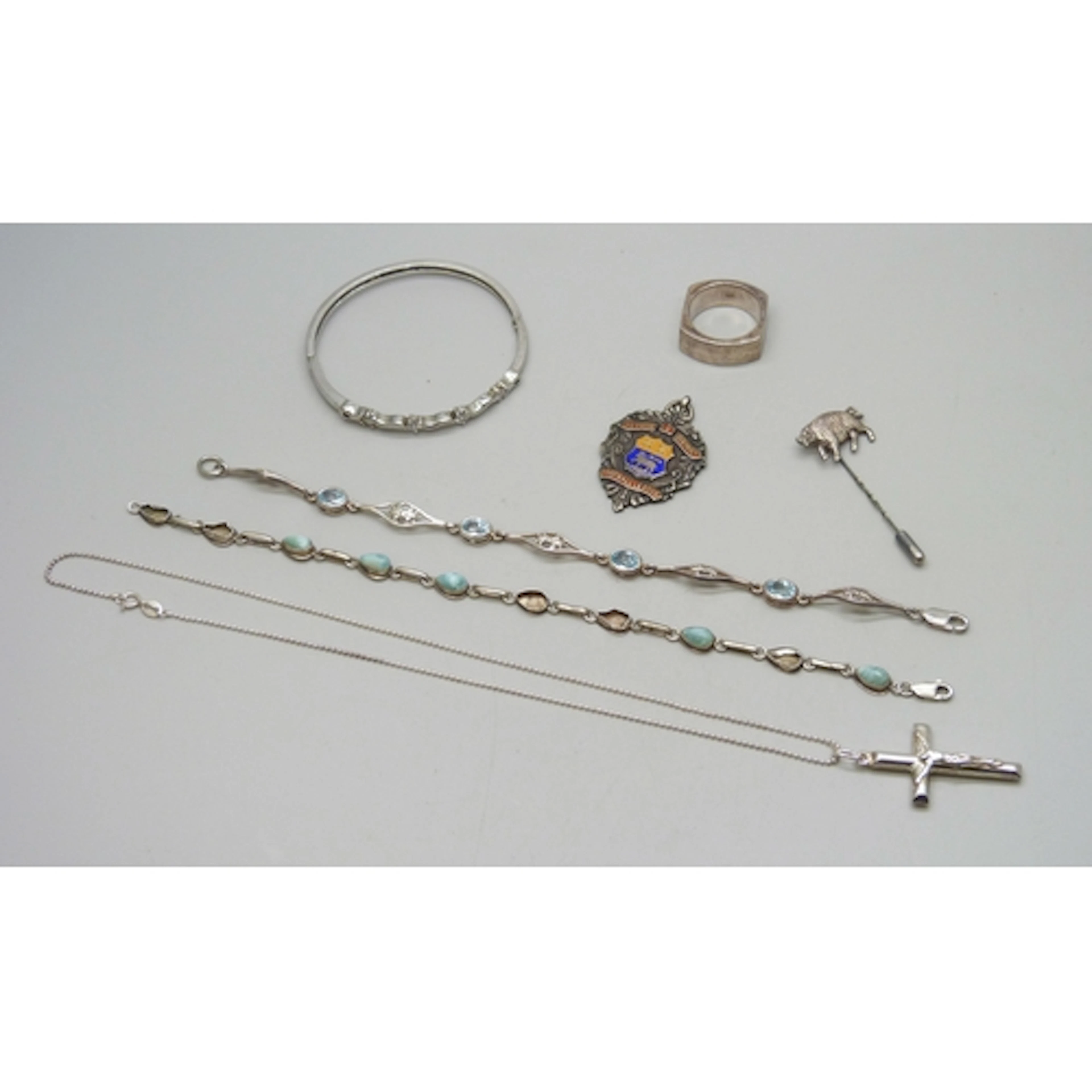 A collection of silver jewellery, including a pig stick pin ...