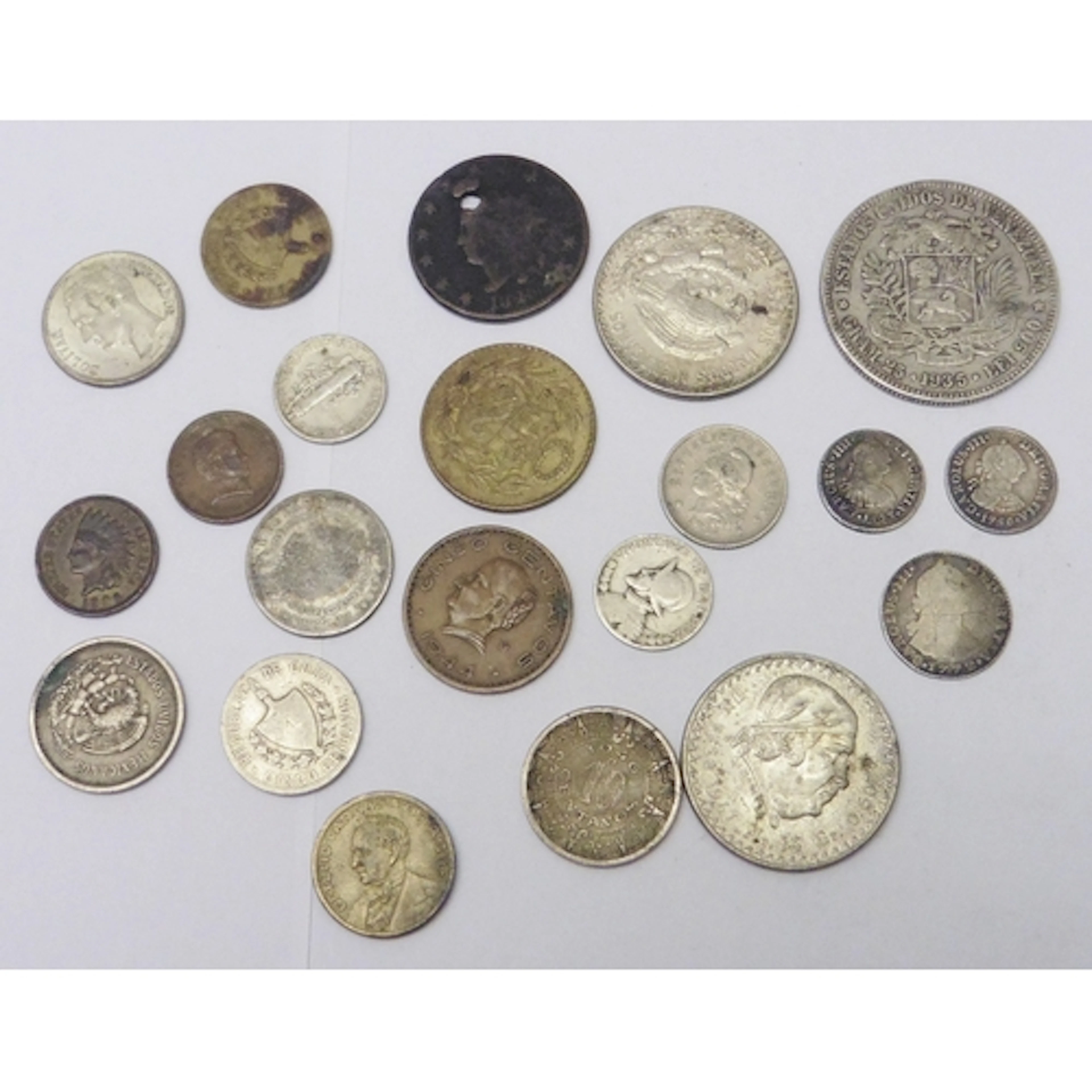 A Spanish Colonial Charles III 1780 1/2 Reales coin; a Spani...