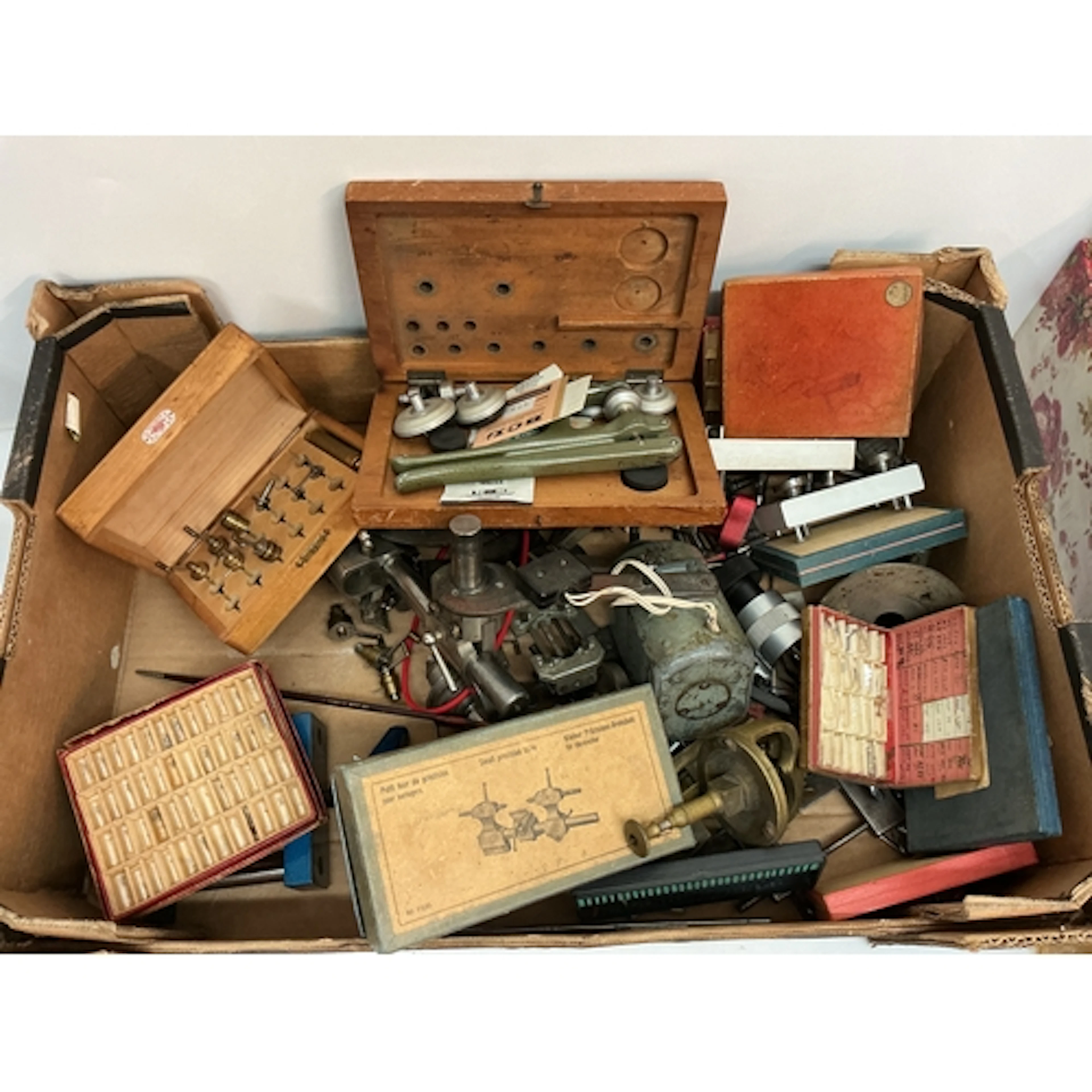 A box containing watch maker’s lathes and tools