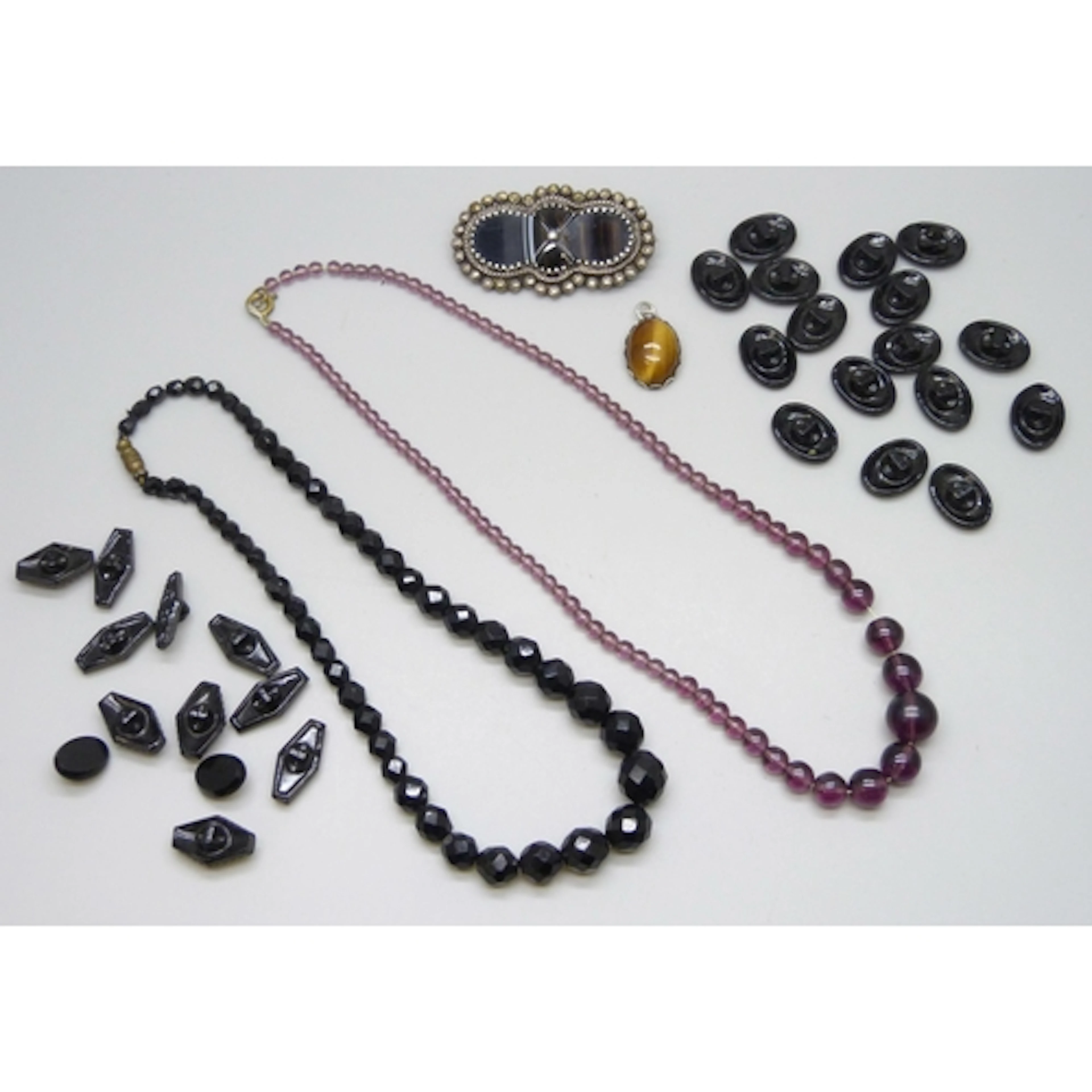 A French jet necklet, two sets of jet style buttons, a tiger...