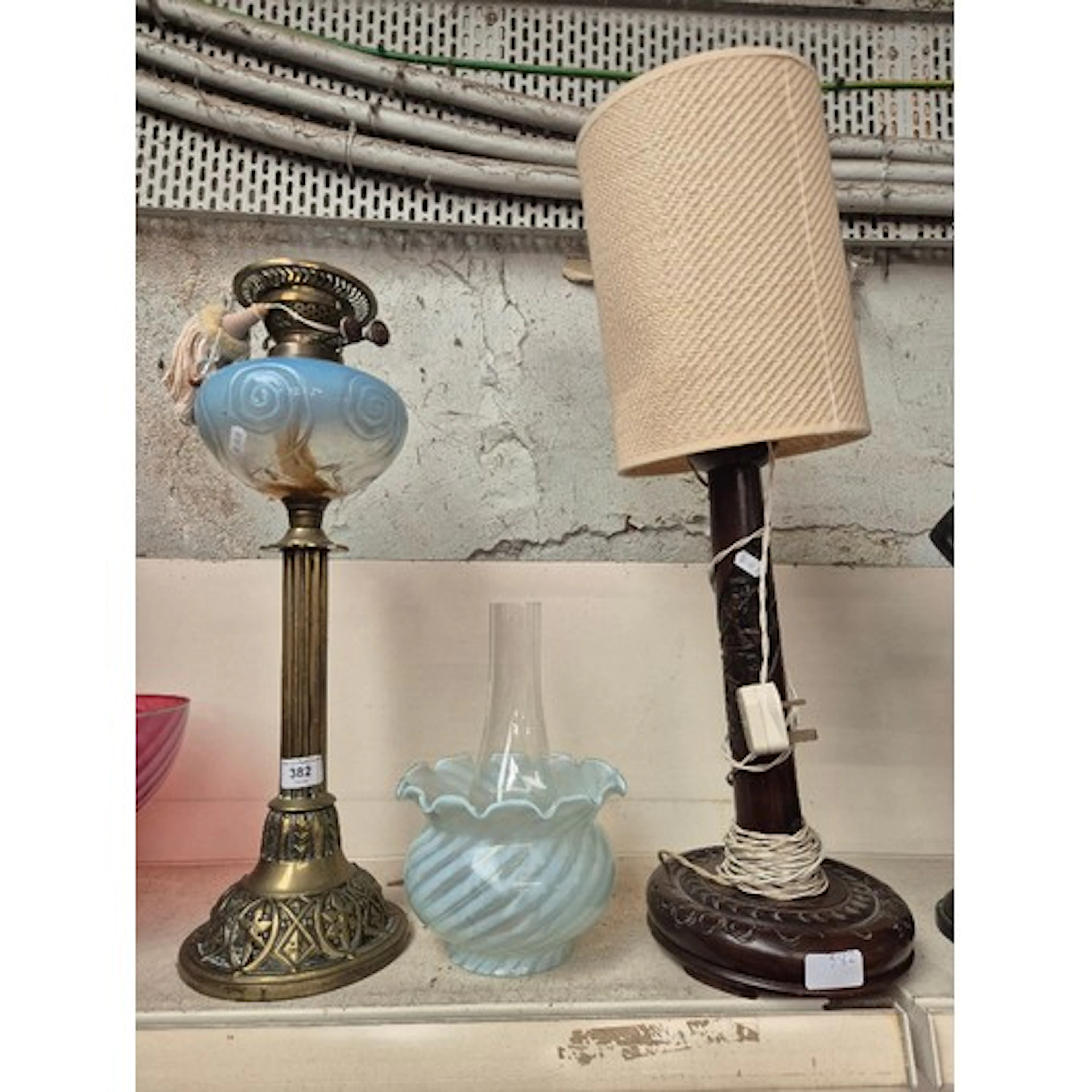 A brass column oil lamp with blue swirled glass reservoir, p...