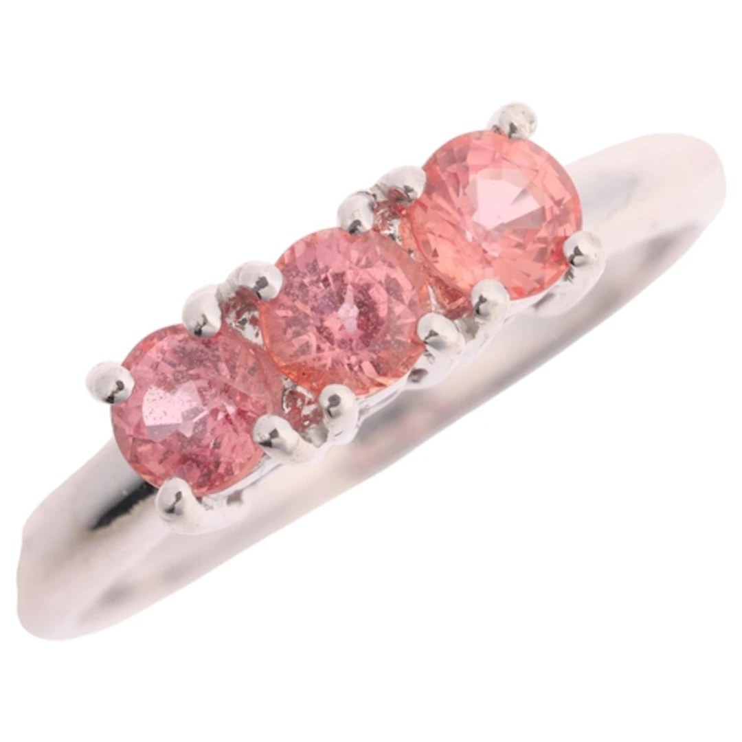 An 18ct white gold three stone orange sapphire ring, claw se...