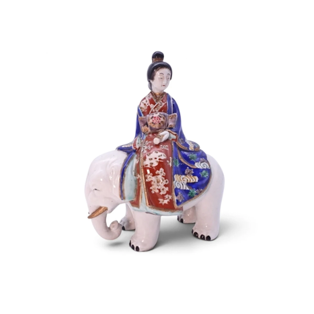An Imari bijin riding on an elephant her robes in typi...