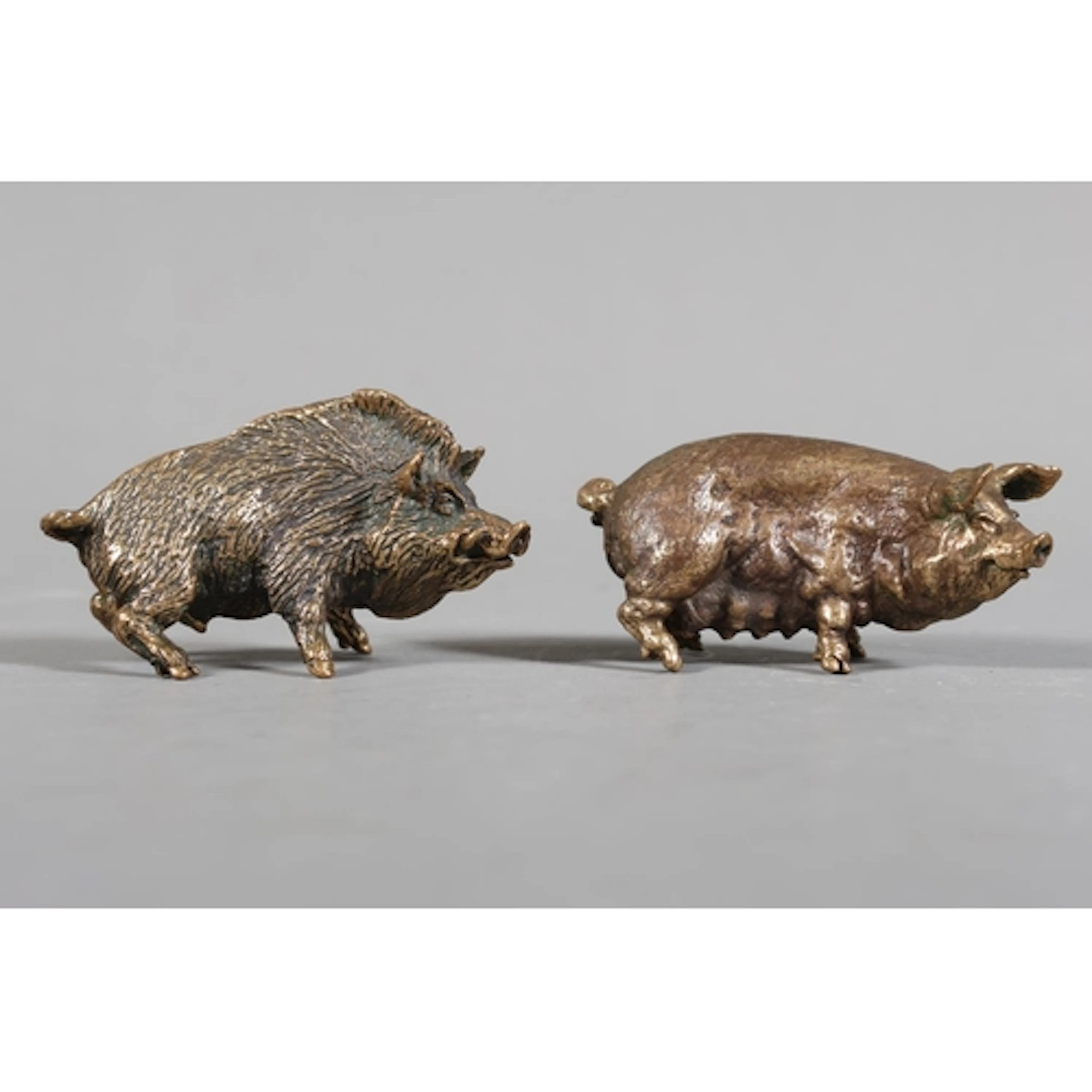 Two small brass figures of a Wild Boar and a Sow.