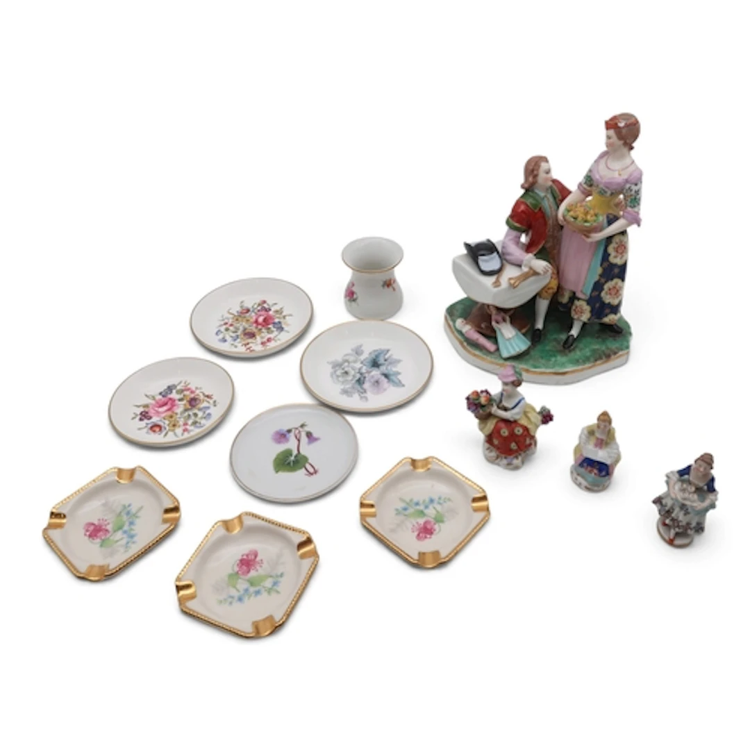 A hard paste porcelain figure group of a couple with painted...
