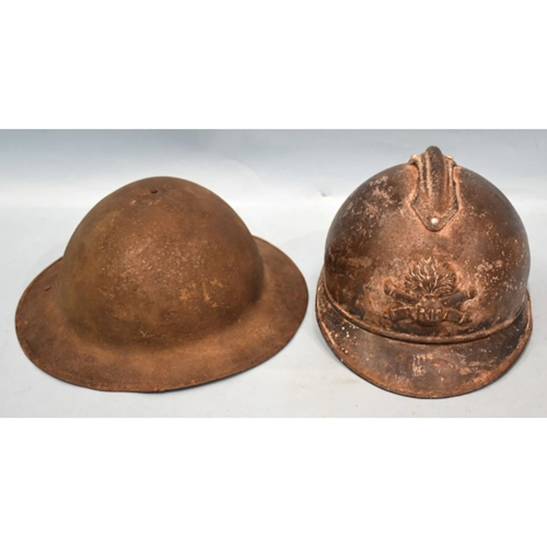 A WWI French 1915 pattern Adrian helmet and a WWI British he...