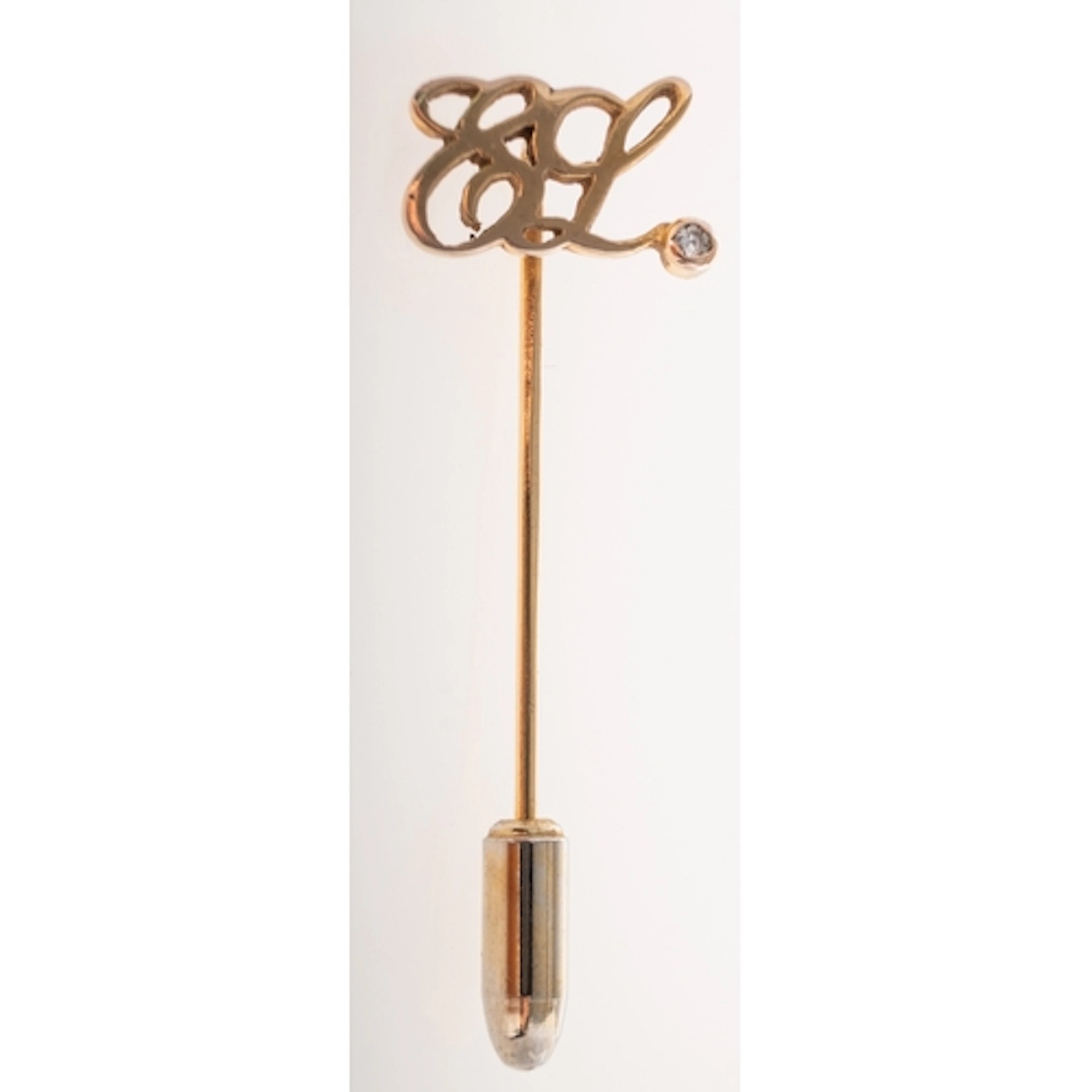 Estee Lauder, a 1980's 9ct gold diamond employee lapel pin, ...