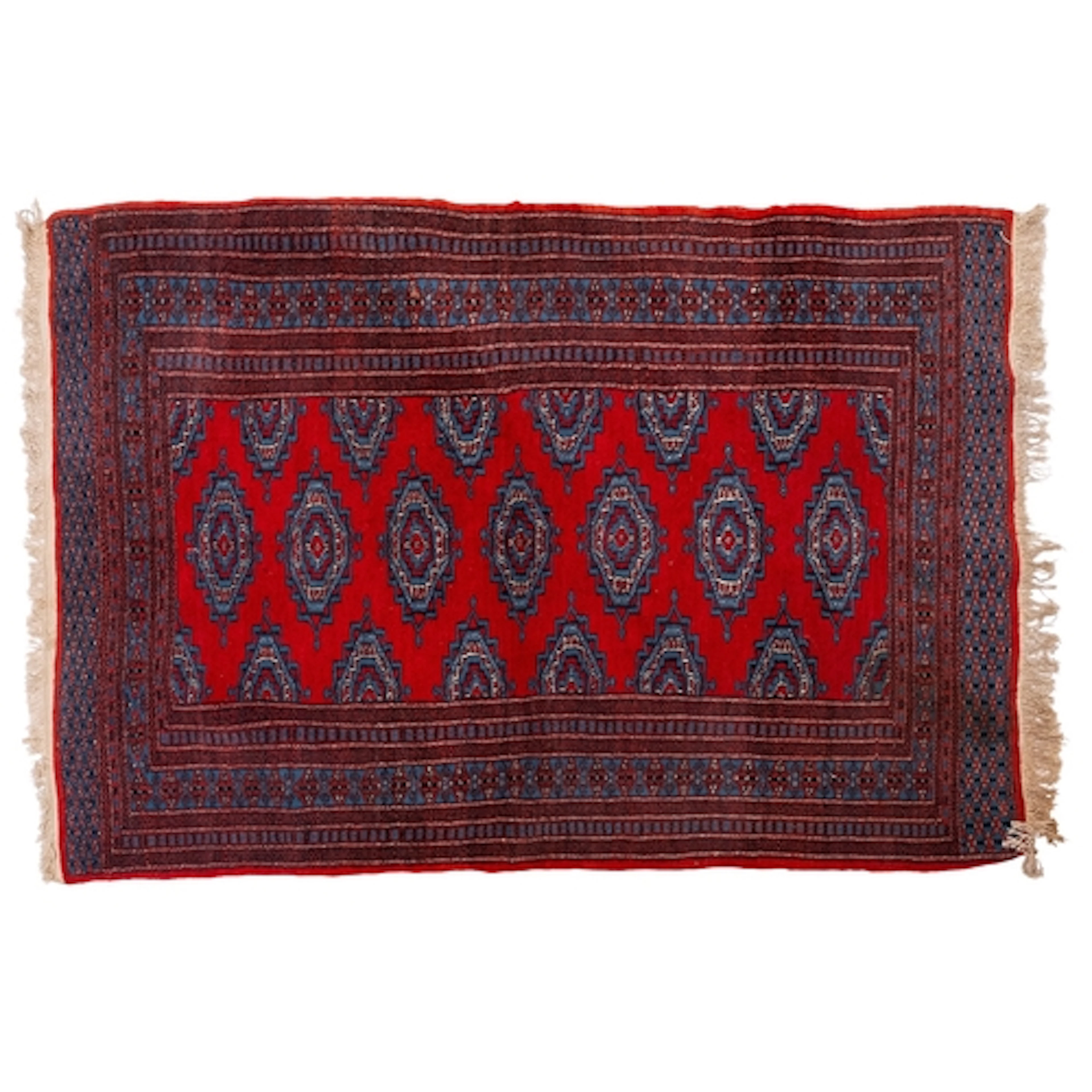 A Pakistan rug of Turkoman design, the red field with steppe...