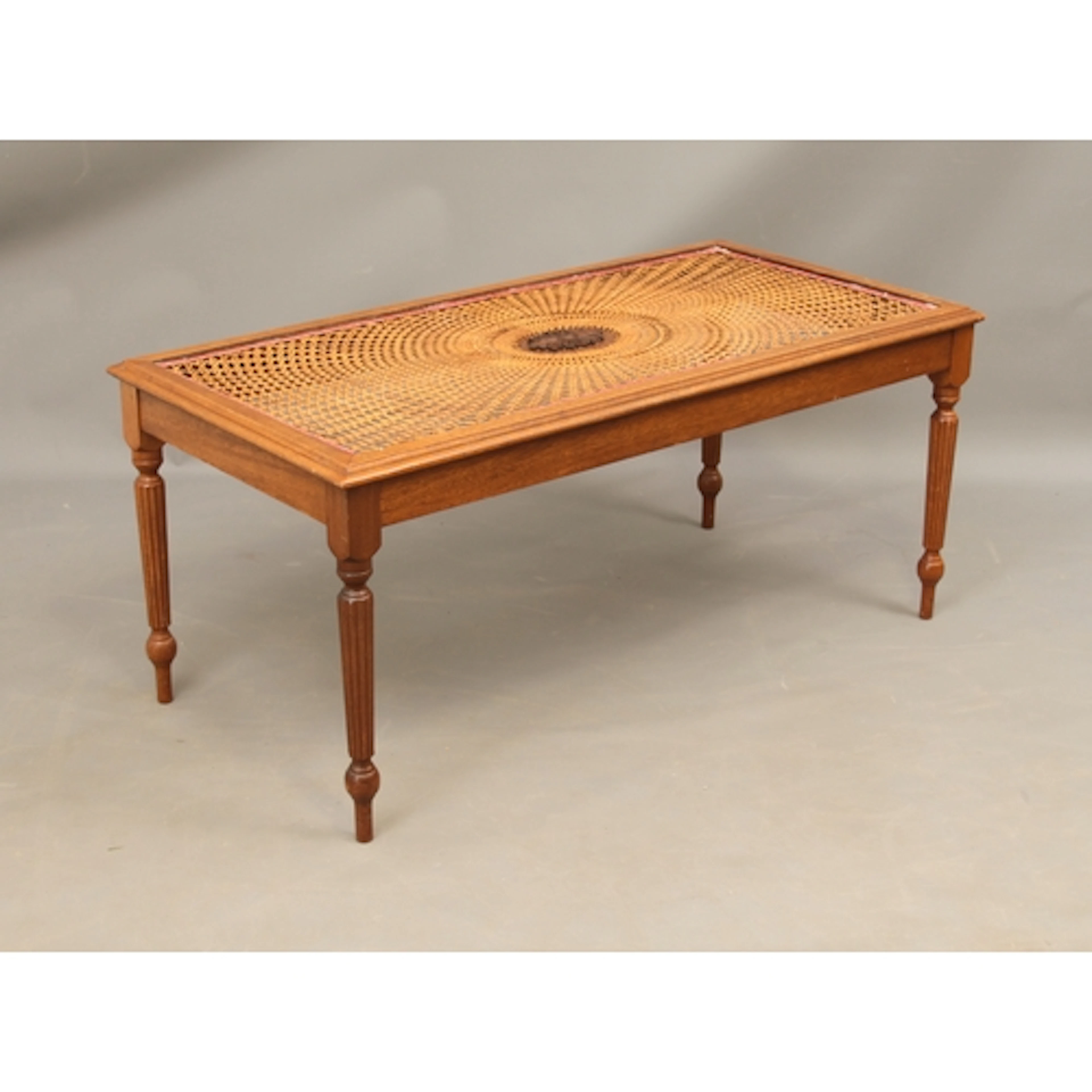 A mahogany and caned coffee table in the Regency taste - the...