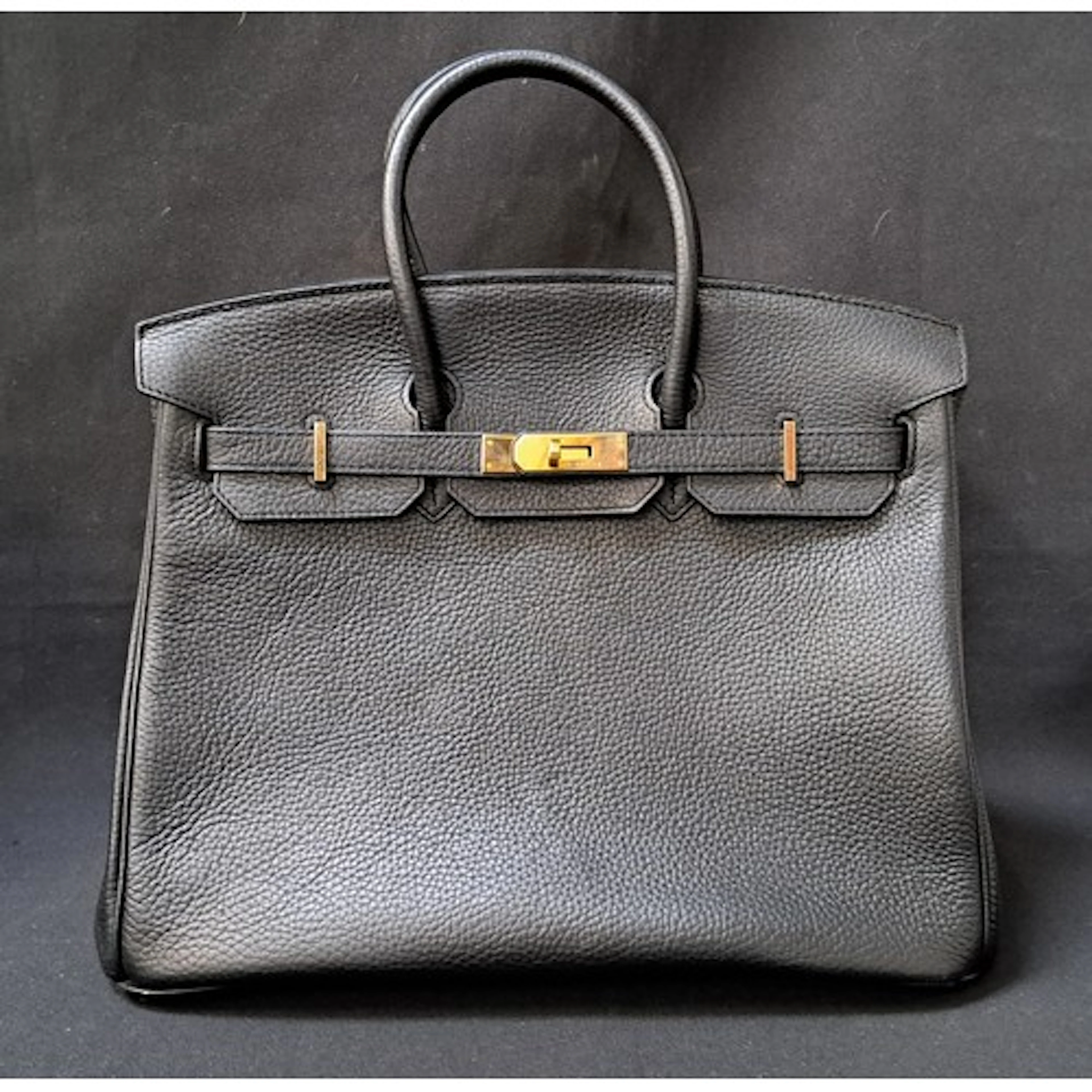HERMÈS BIRKIN 35 BLACK LEATH HANDBAG with gold metal hardwa...