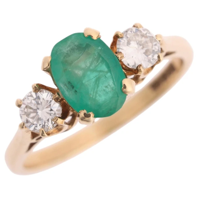 A 9ct gold three stone emerald and diamond ring, maker MJ, i...