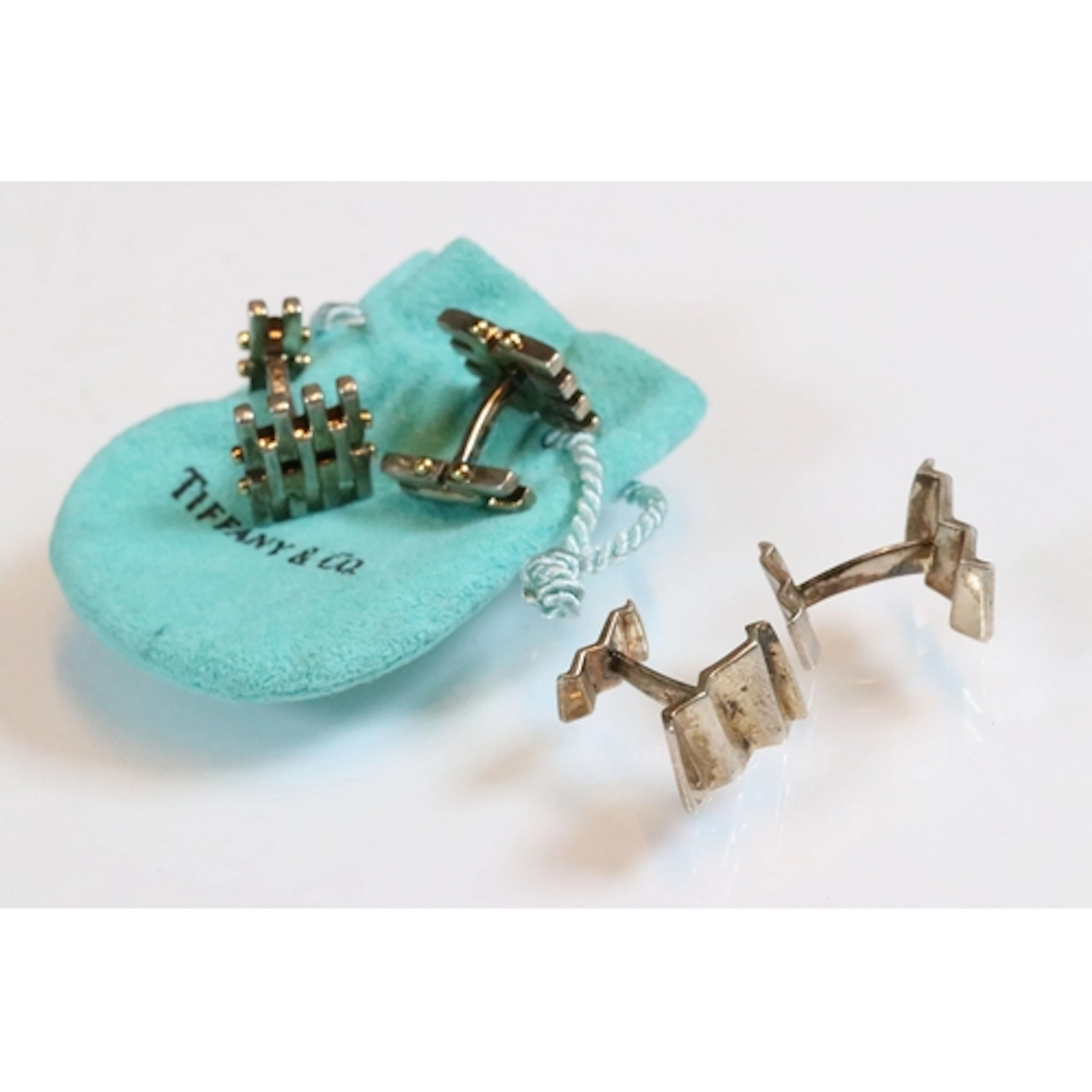 Two pairs of Tiffany & Co silver cufflinks to include a gate...