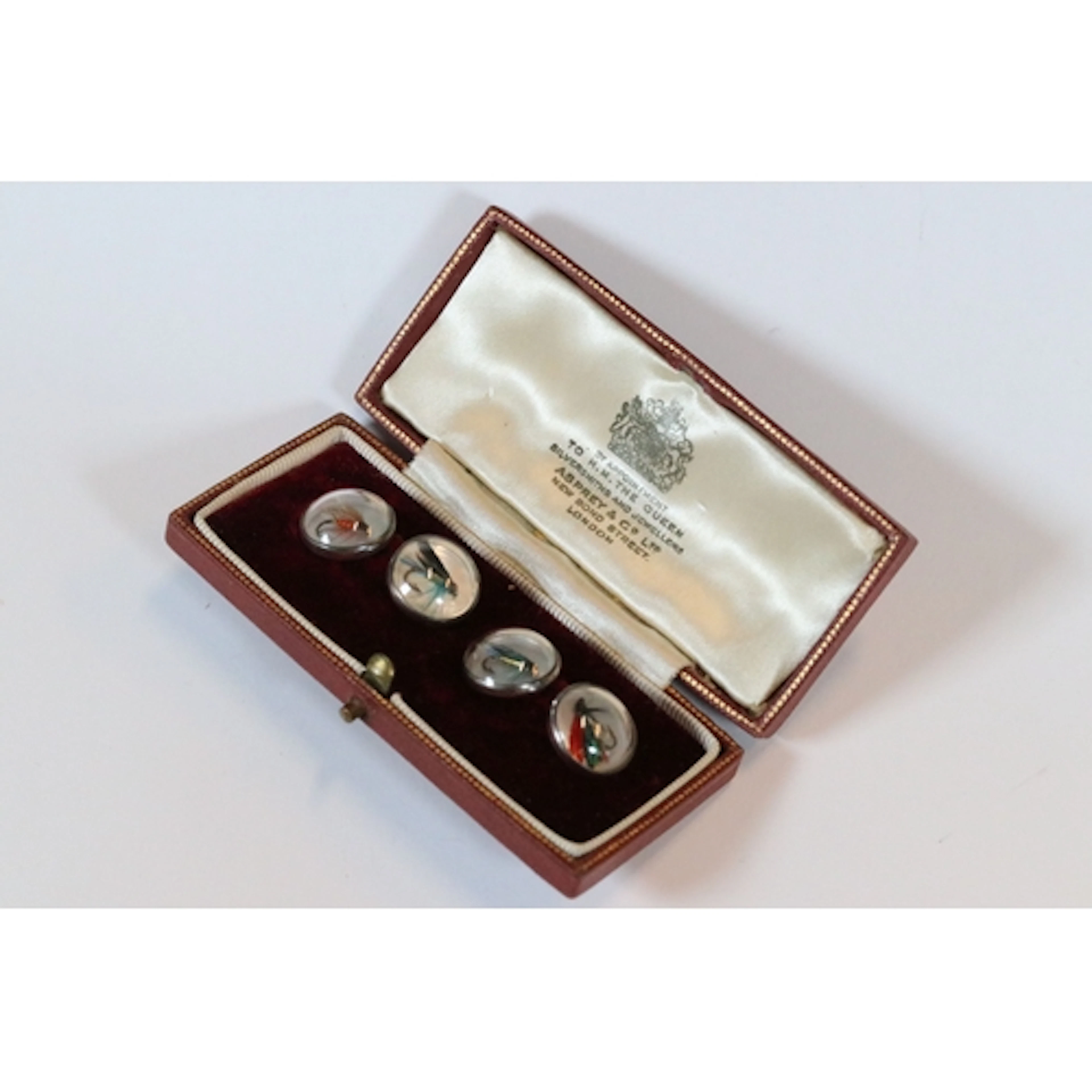Pair of silver mounted cufflinks of circular form, with fish...