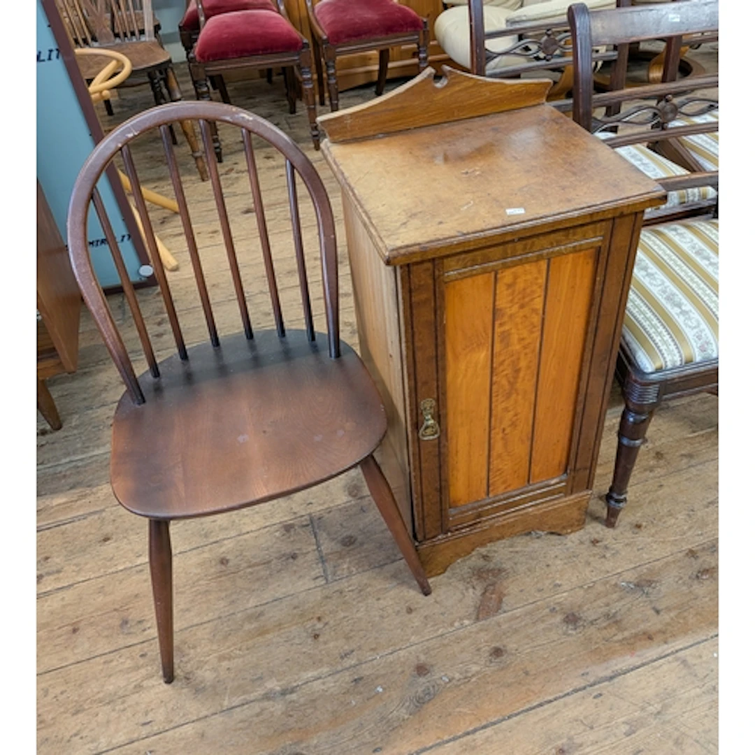 An Edwardian walnut bedside cupboard and a spindle back Wind...