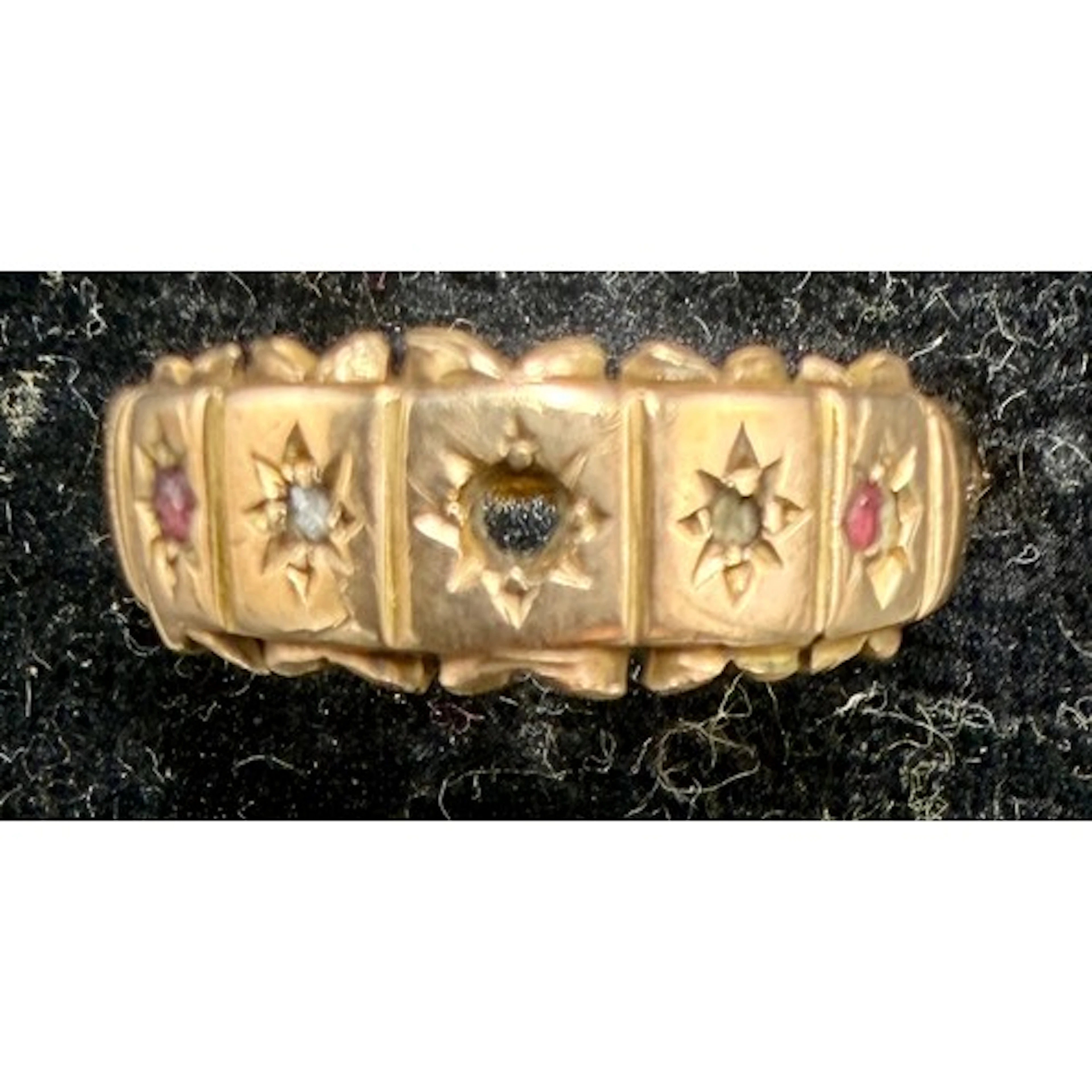 A 22 carat gold ring set with pink and clear stones (one mis...