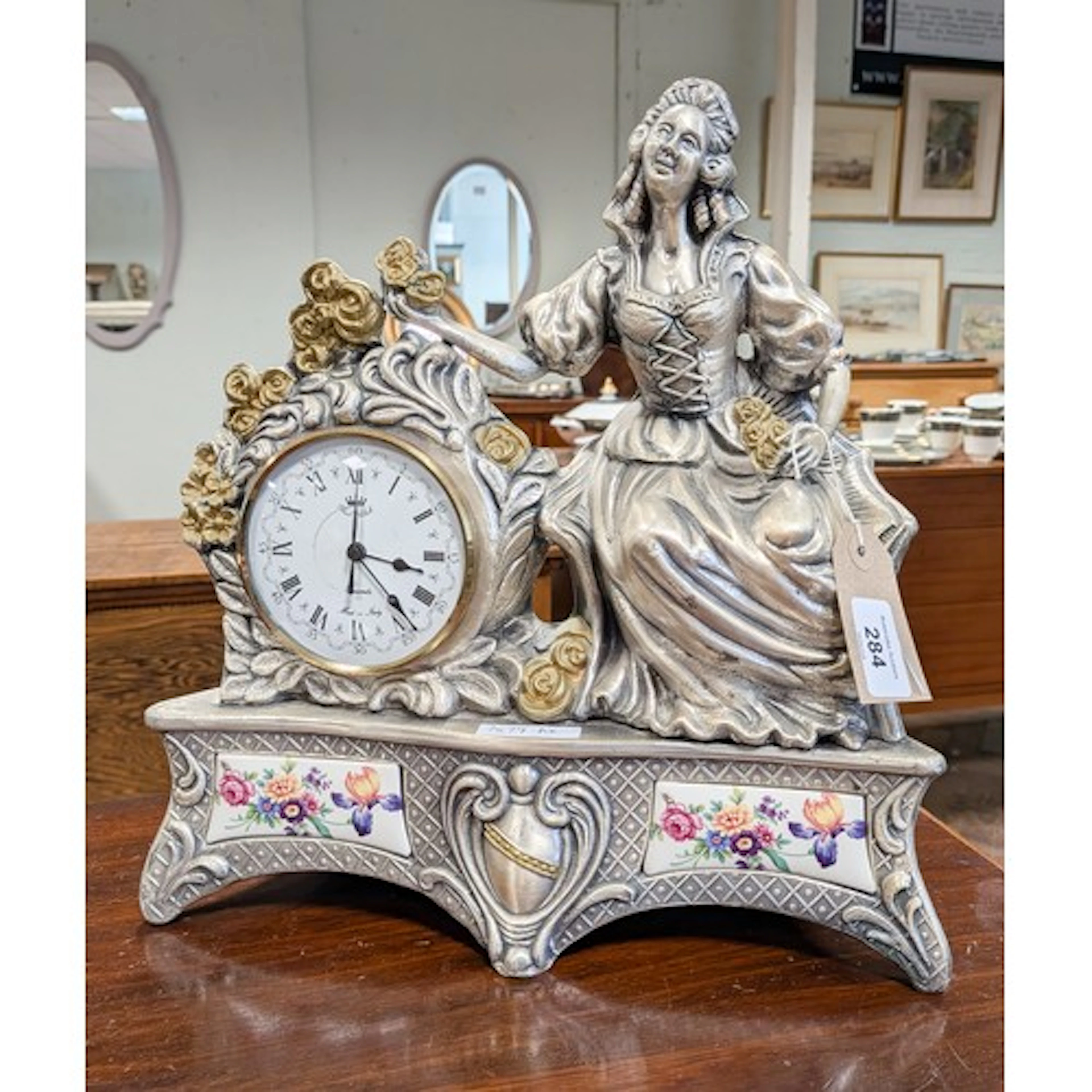 A Victorian style battery operated figure mounted clock in s...