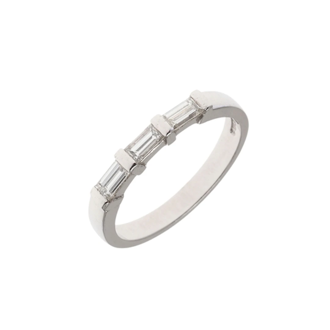 A DIAMOND HALF HOOP RING. mounted with three baguette-cut di...