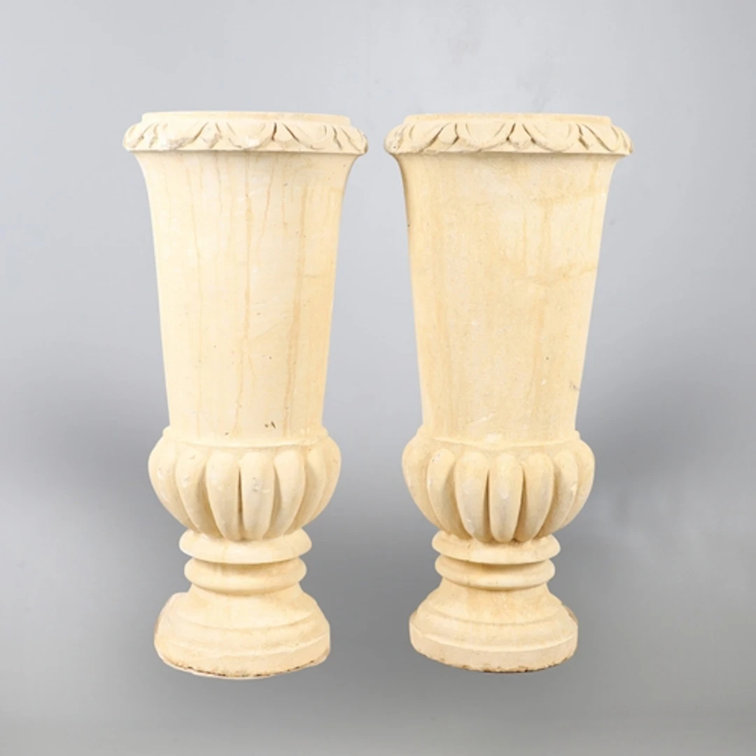 A PAIR OF CONTEMPORARY EGYPTIAN CARVED STONE URNS. of taperi...