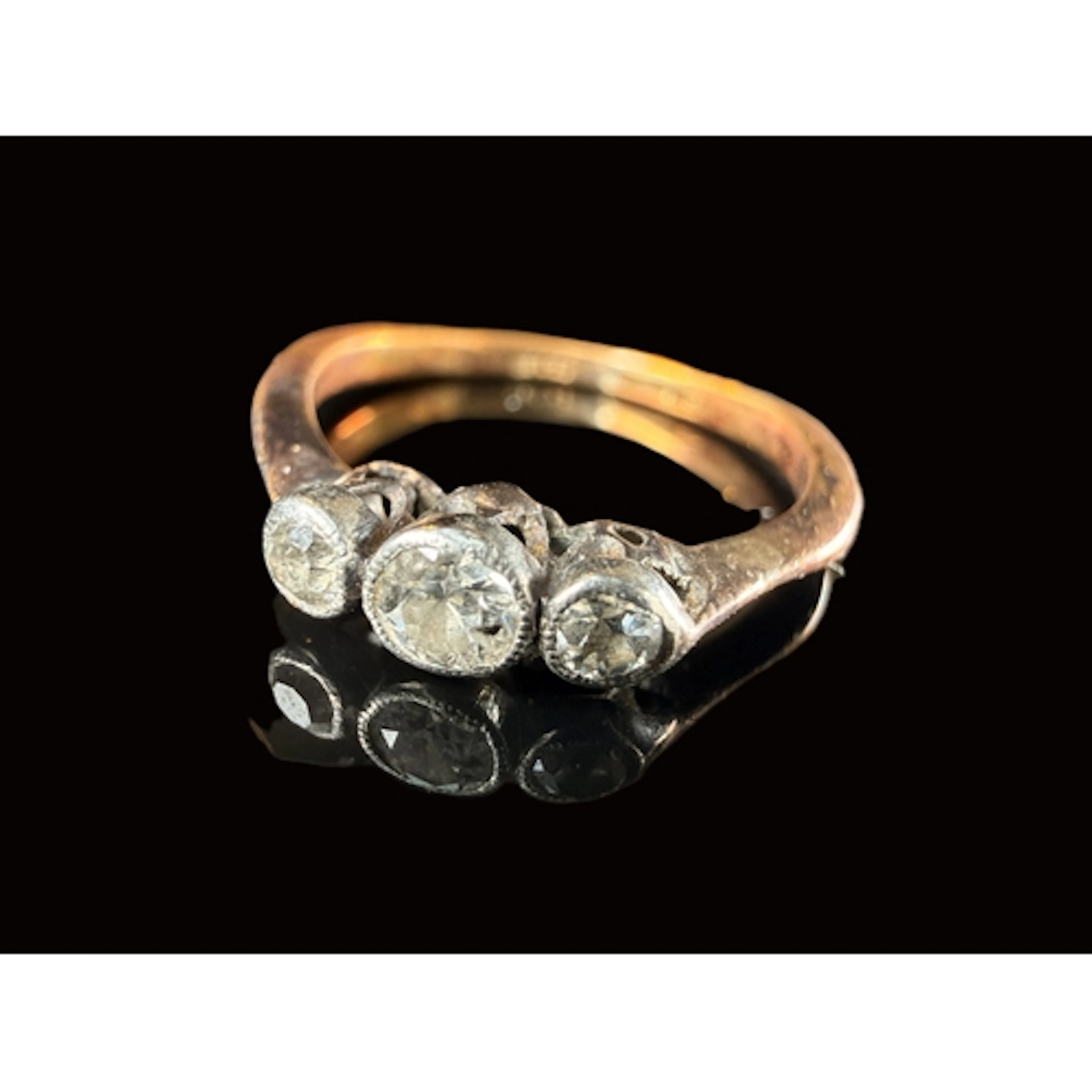 An 18ct gold diamond set ring with three old cut diamonds 2....