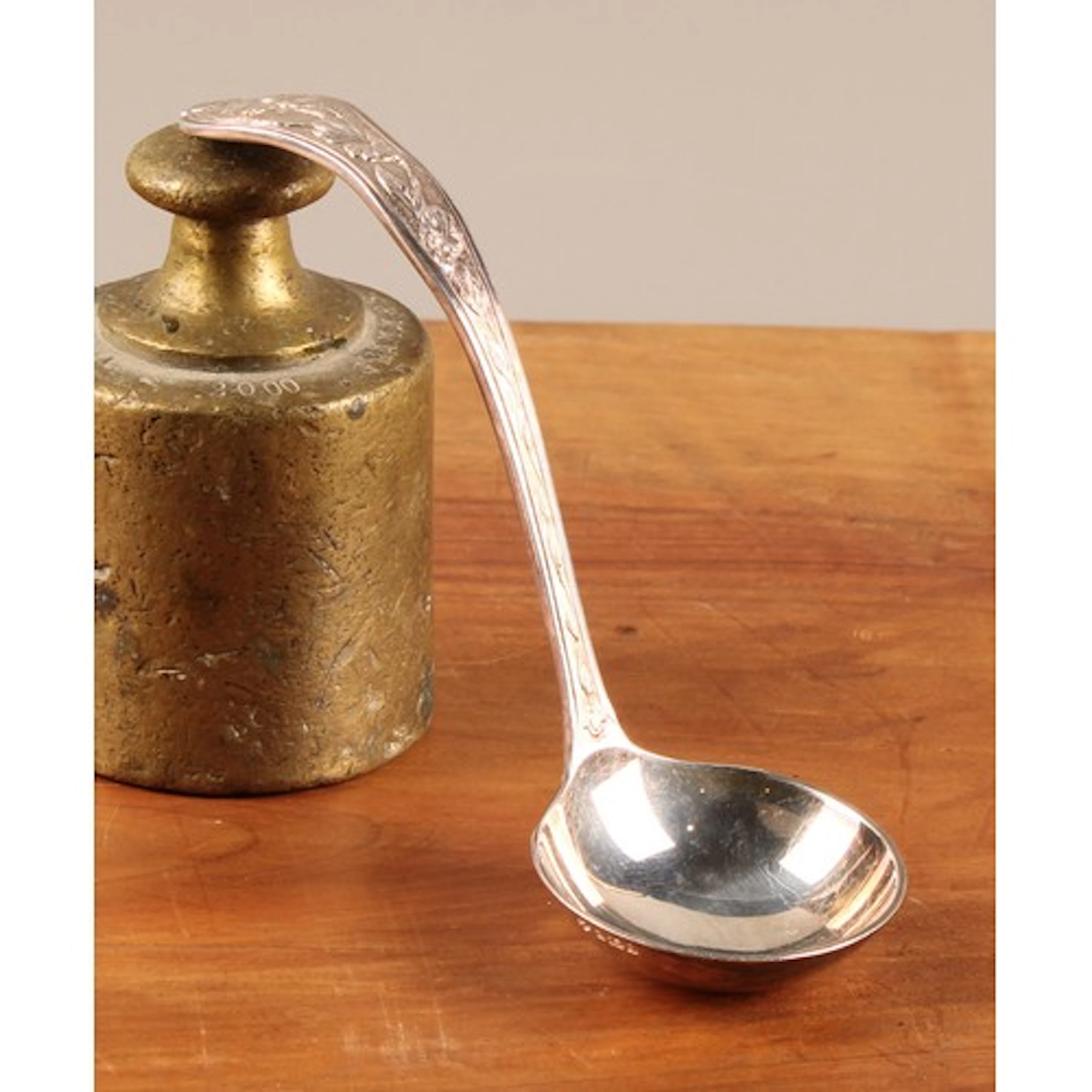 Asprey & Co - an Elizabeth II silver ladle, the handle chase...