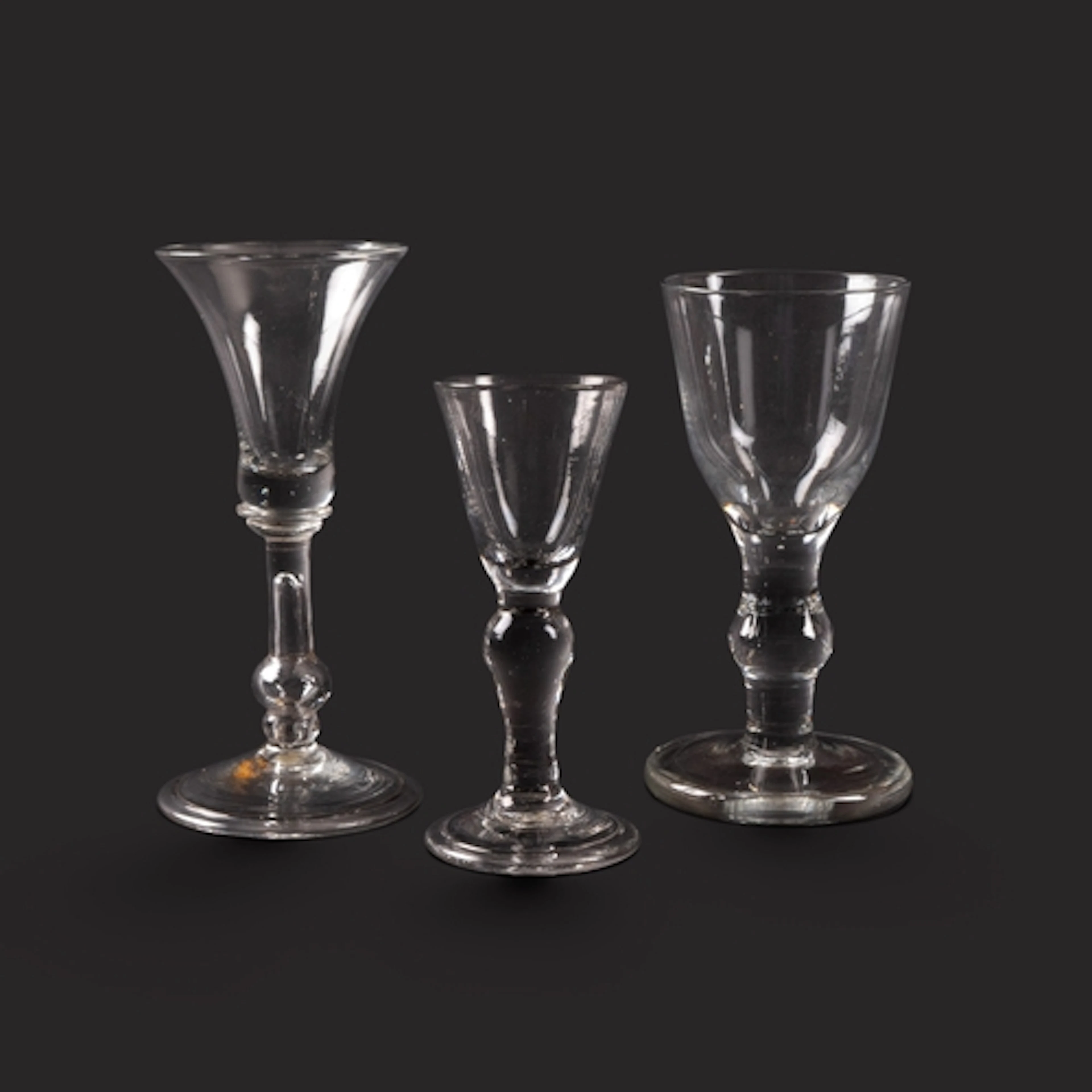 A small baluster gin glass and two wine glasses, c.1725-40, ...
