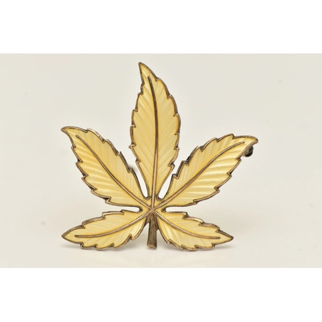 A NORWEGIAN ENAMEL LEAF BROOCH, decorated with yellow guillo...