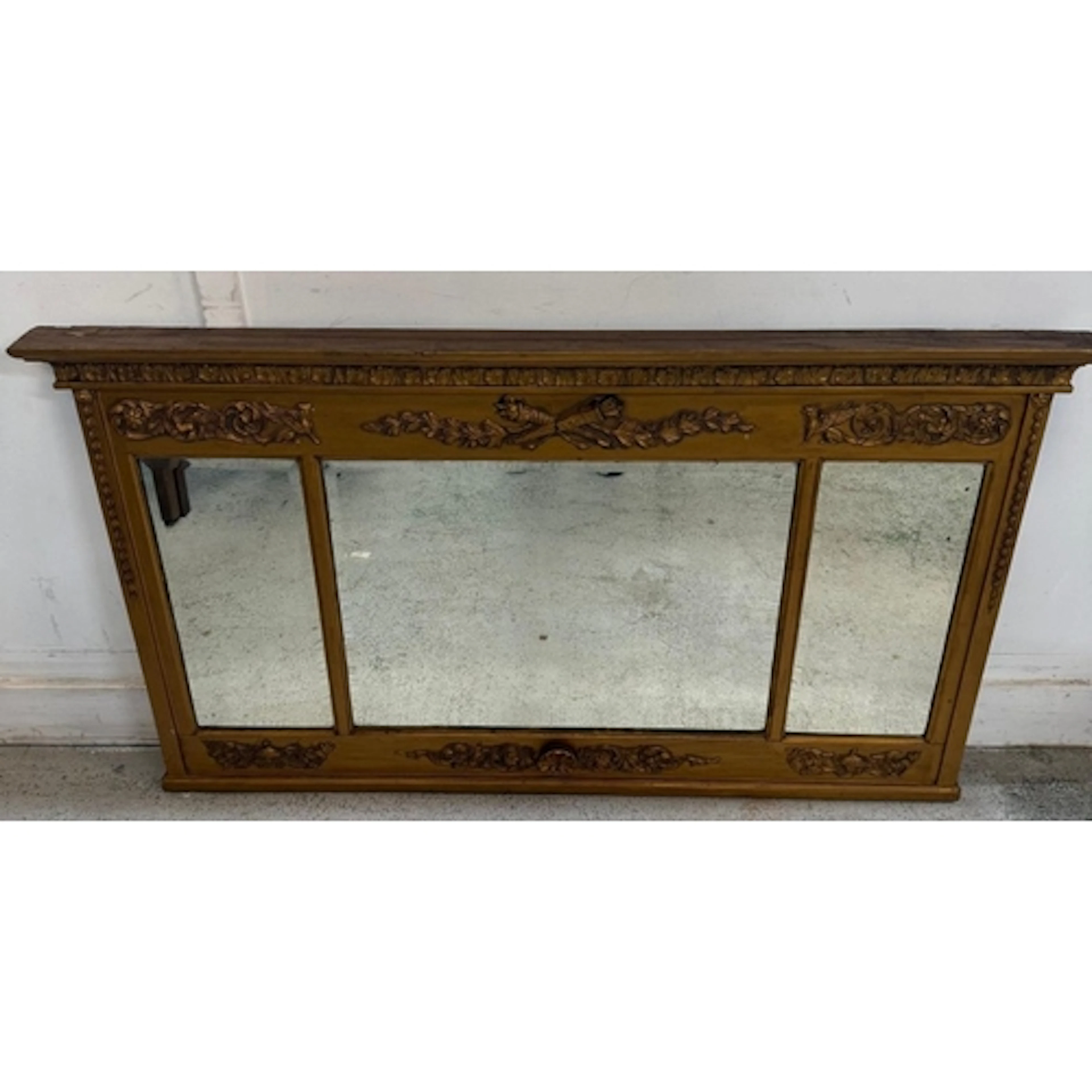 A gold-painted triple plate over mantel mirror with scrollin...